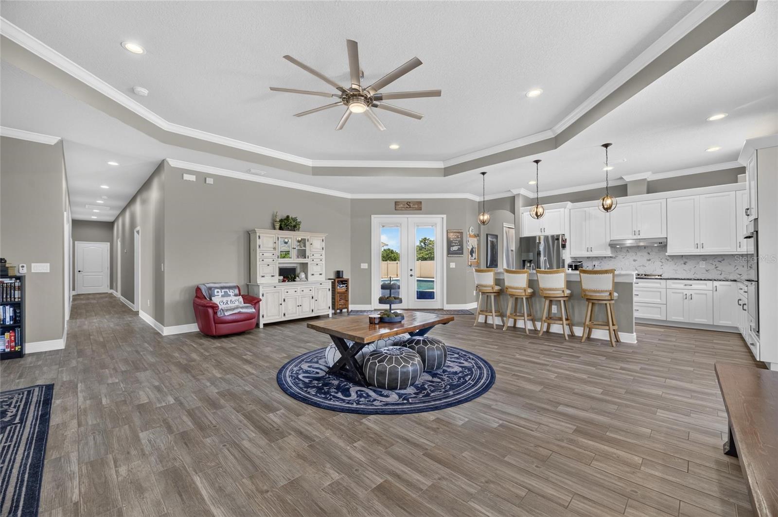 The 800-SF great room at the heart of the home comprises the kitchen...