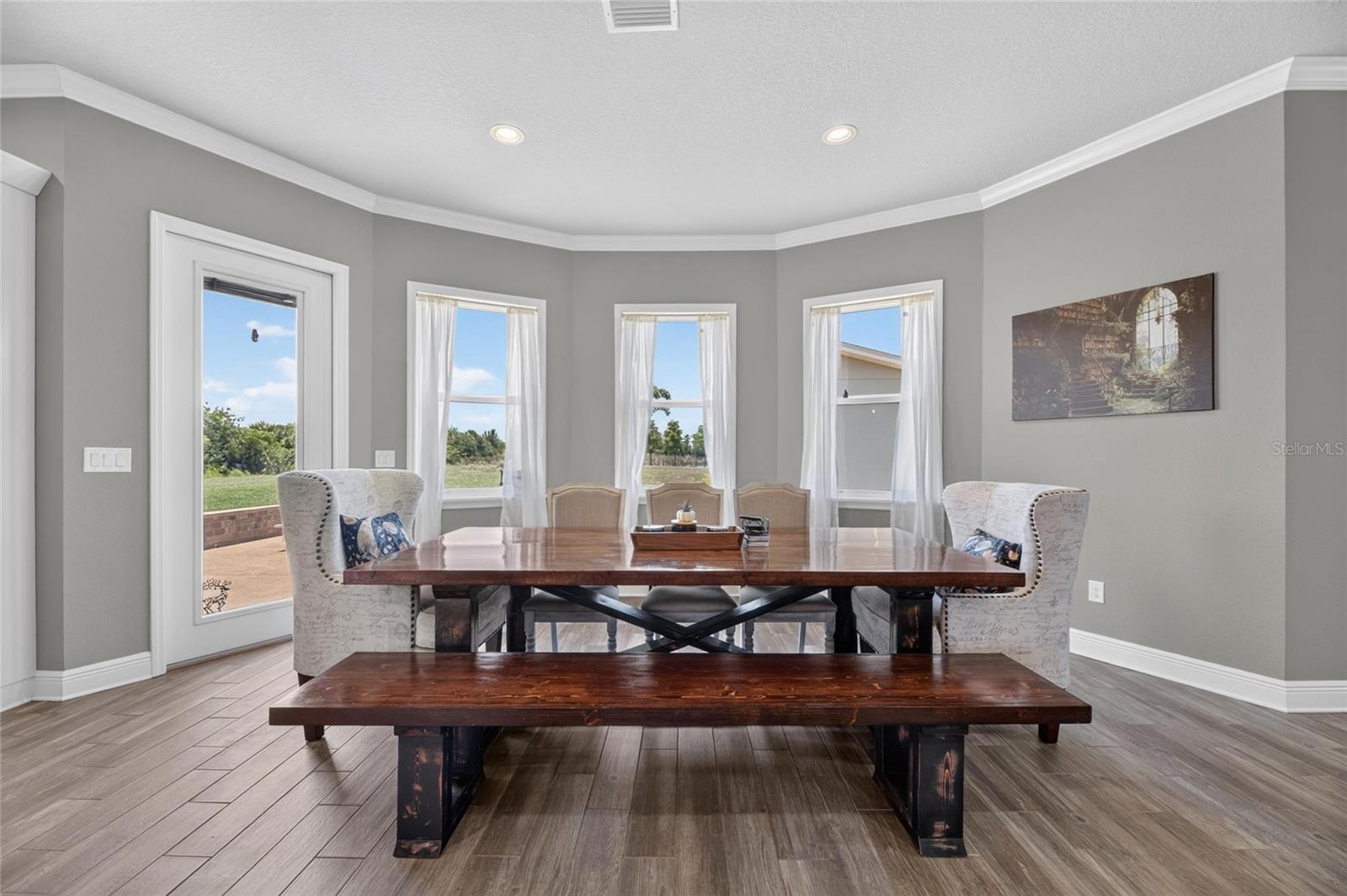 The bay-windowed dining room opens to an outdoor patio.
