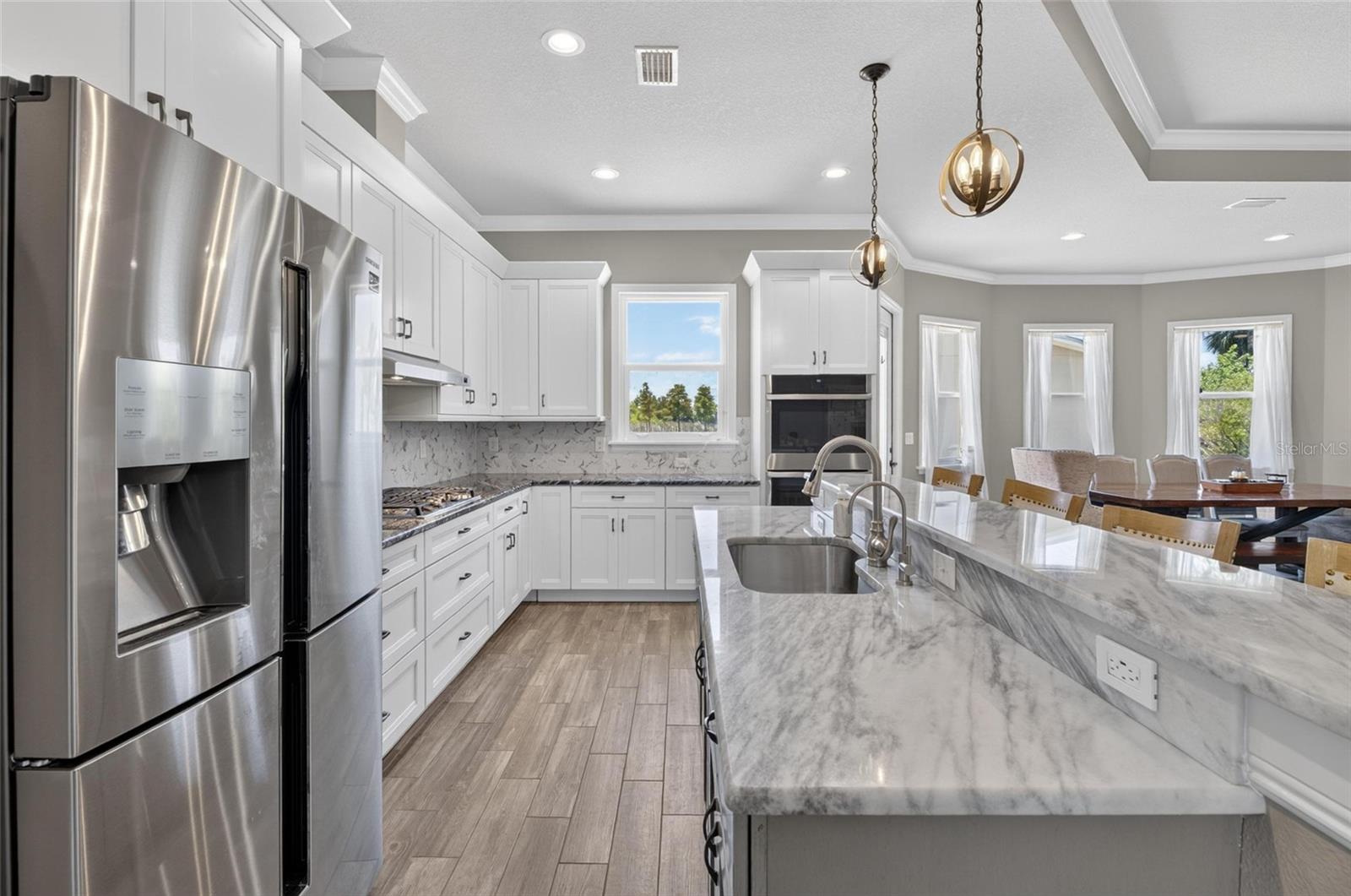 The kitchen boasts stone counters and stainless-steel appliances...