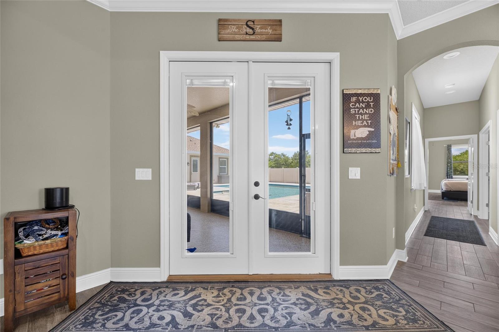 A hallway at the south end of the home leads to the owner suite and an office or 2nd bedroom.
