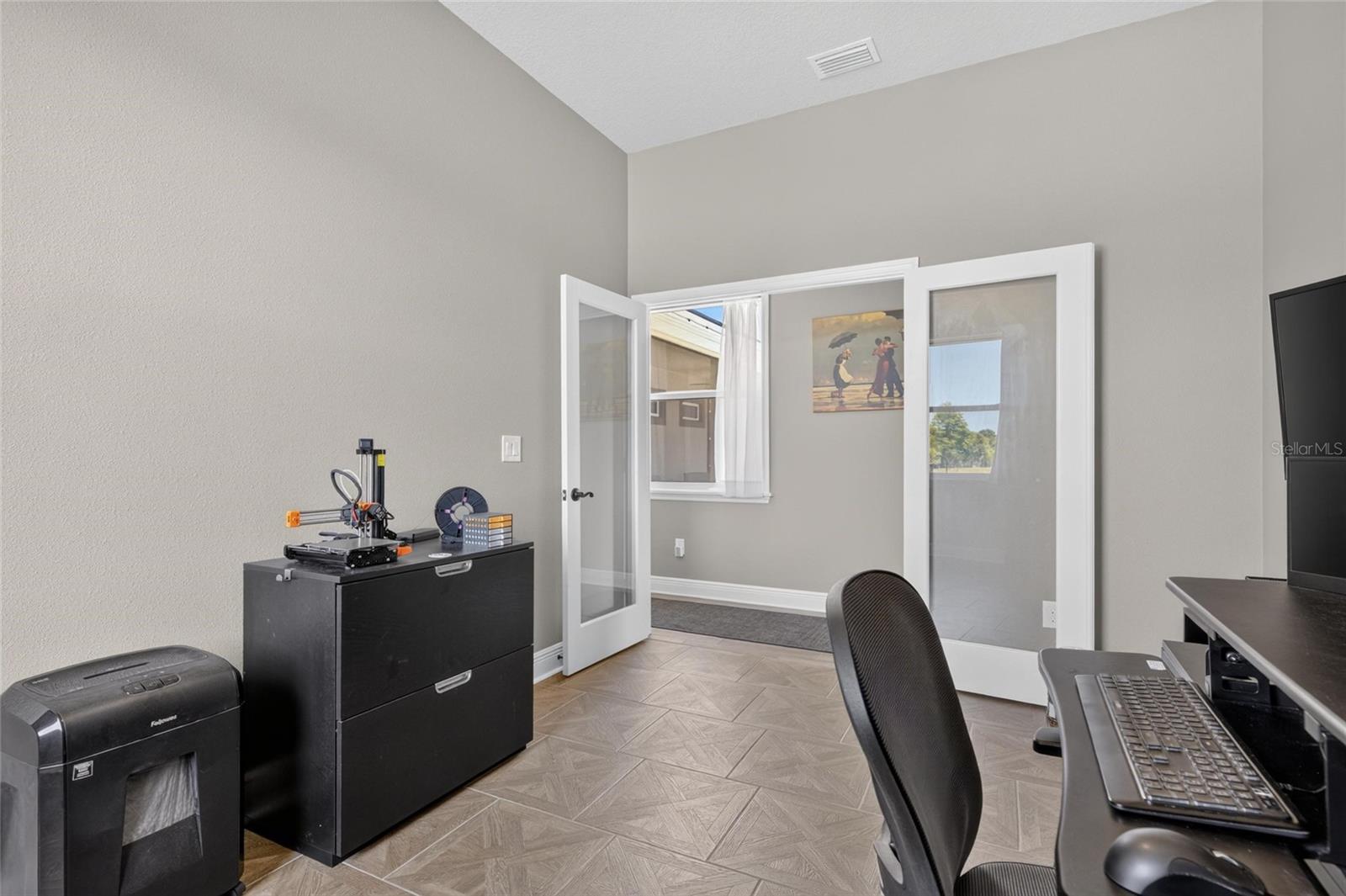 Its French doors open to that hallway from the great room.