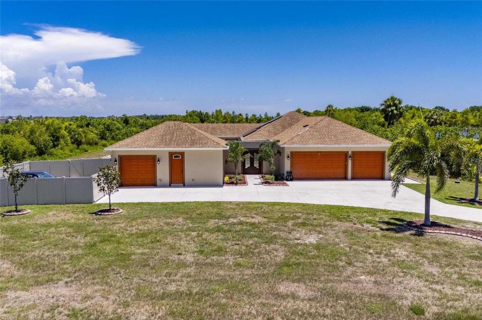 The estate faces north, its entry flanked by 4 garage bays.