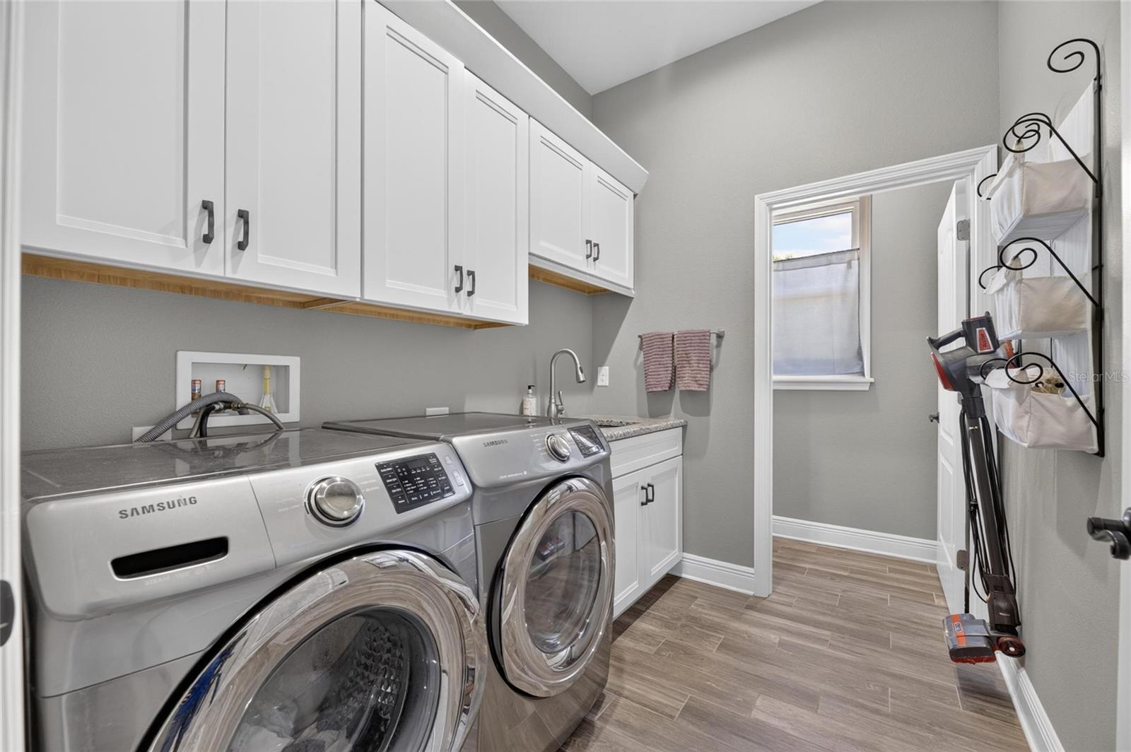 Beyond all those rooms, you'll find this laundry that leads...
