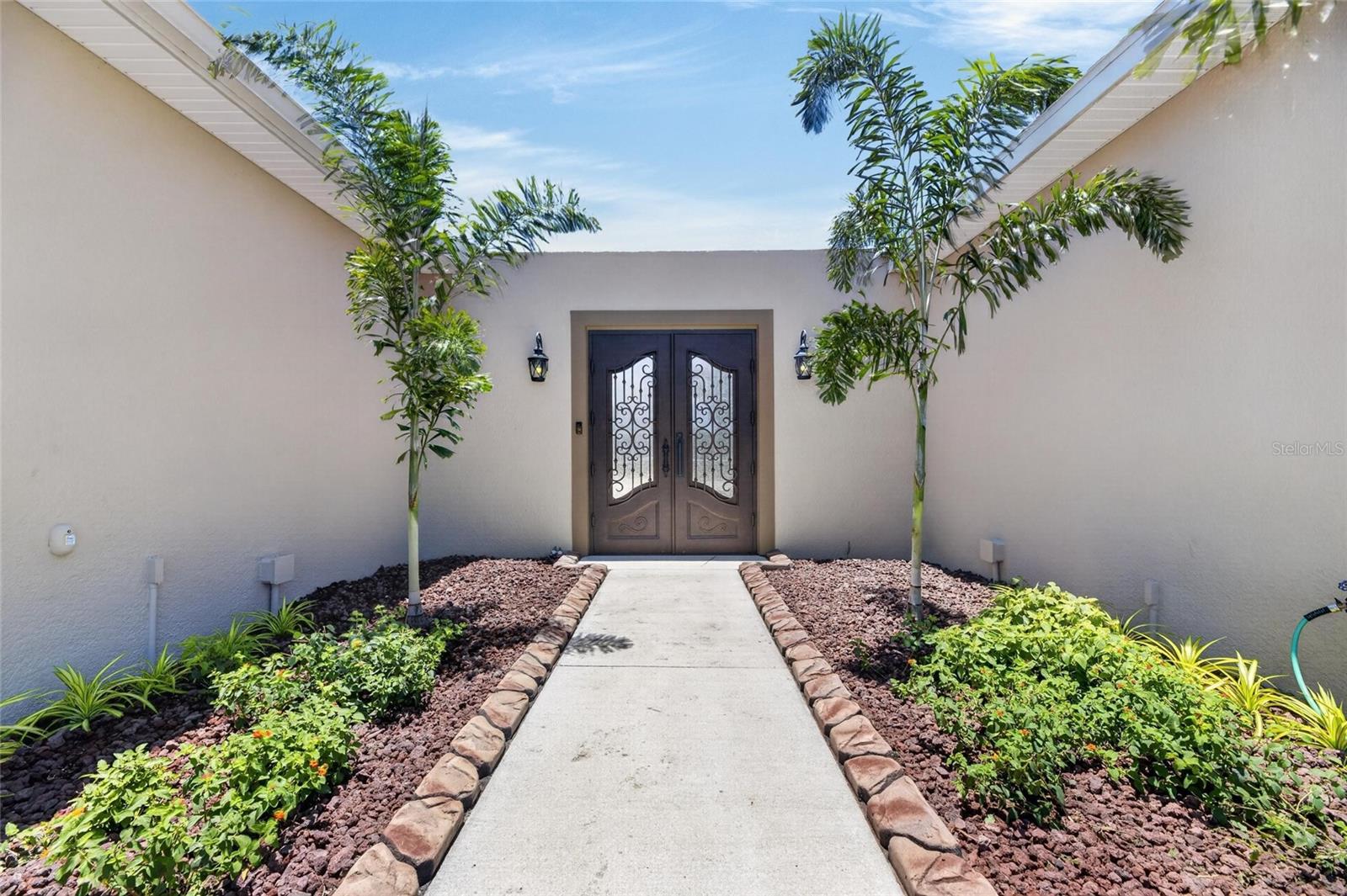 A landscaped front walk beckons you...