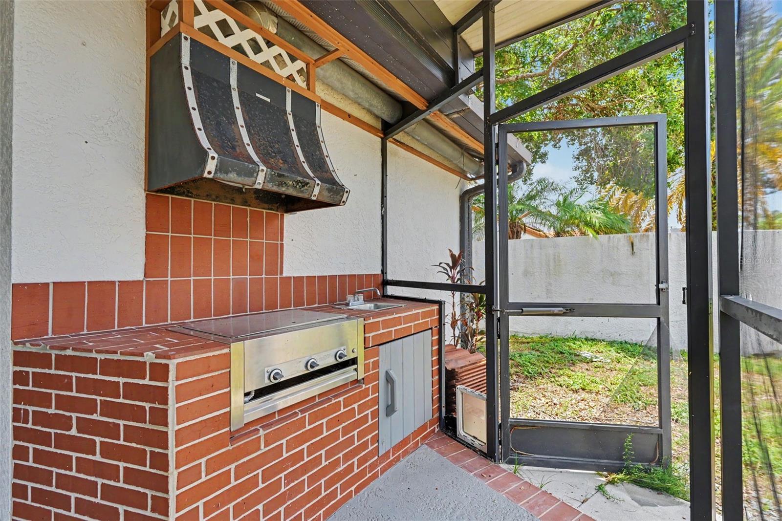 huge lanai with outdoor kitchen