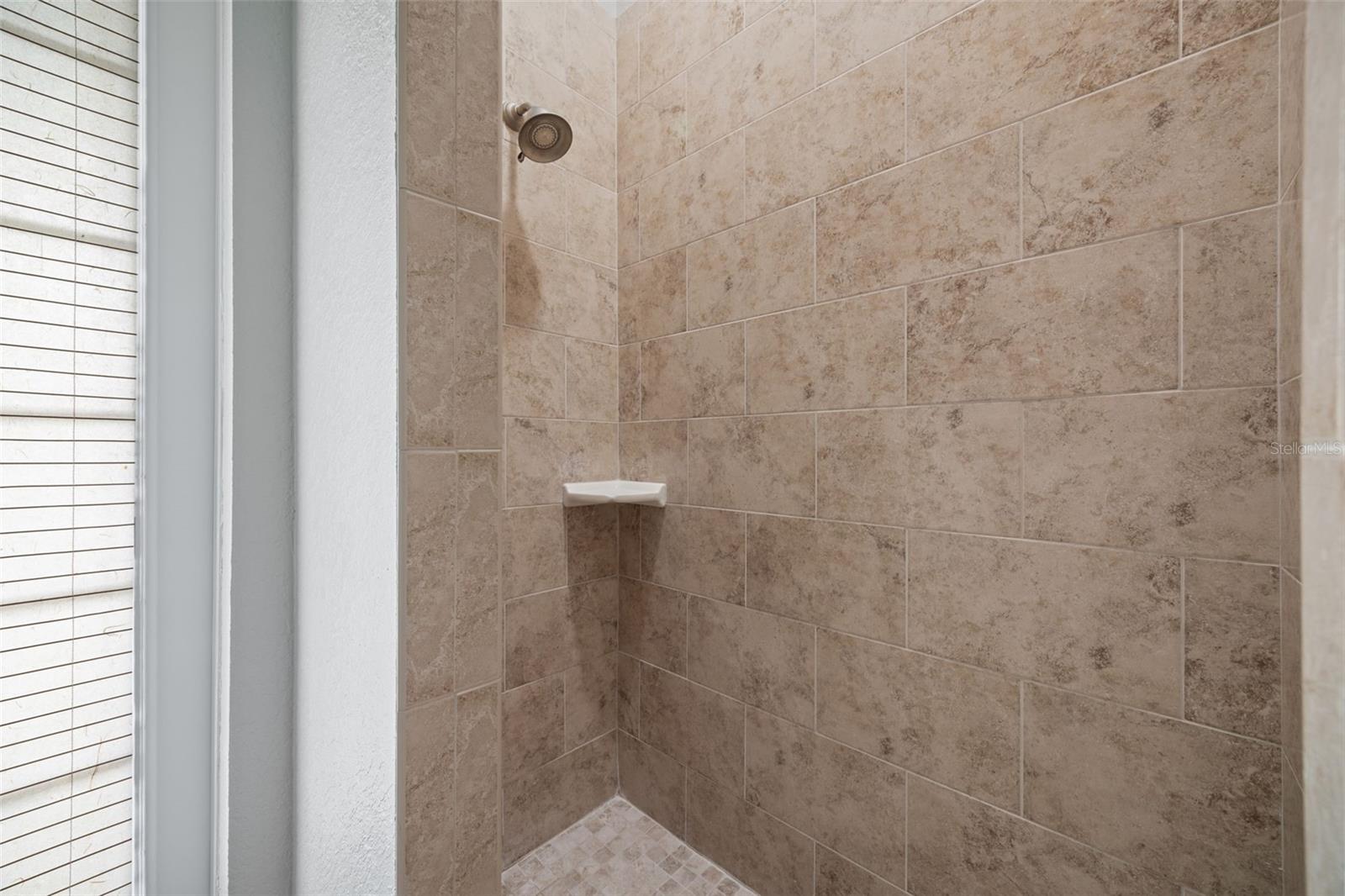 1st floor bathroom tiled shower.