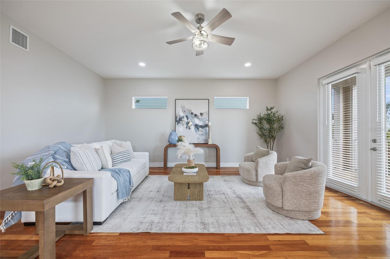 Spacious living room with beautiful natural sunlight throughout.