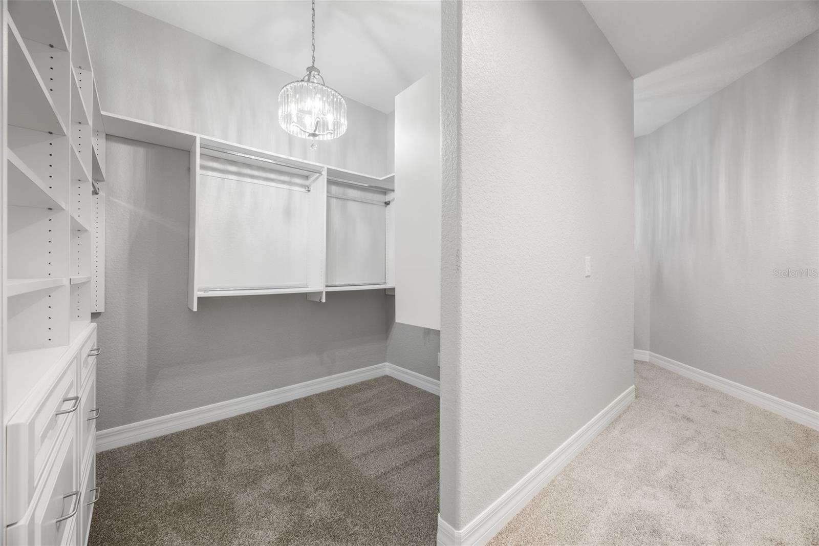 Master closet with two separate spaces and built-in organization.