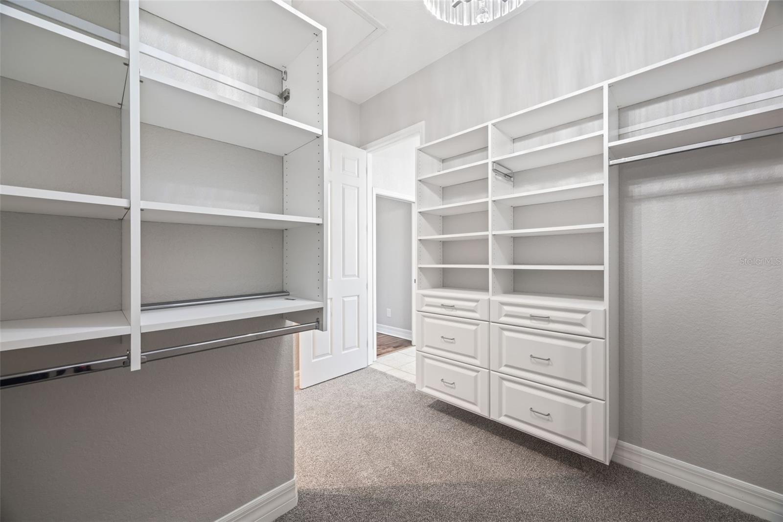 Master closet with two separate spaces and built-in organization.