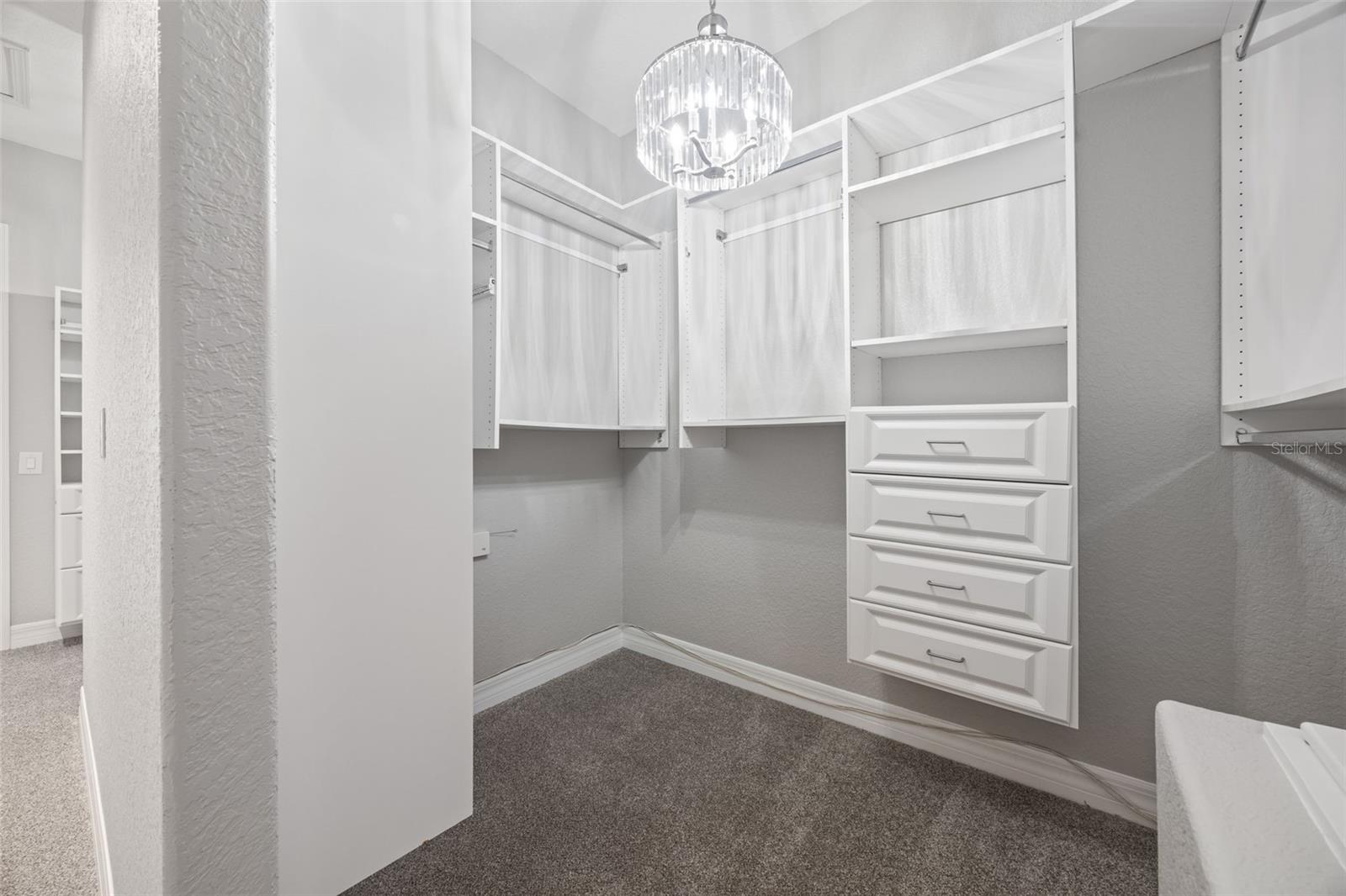 Master closet with two separate spaces and built-in organization.