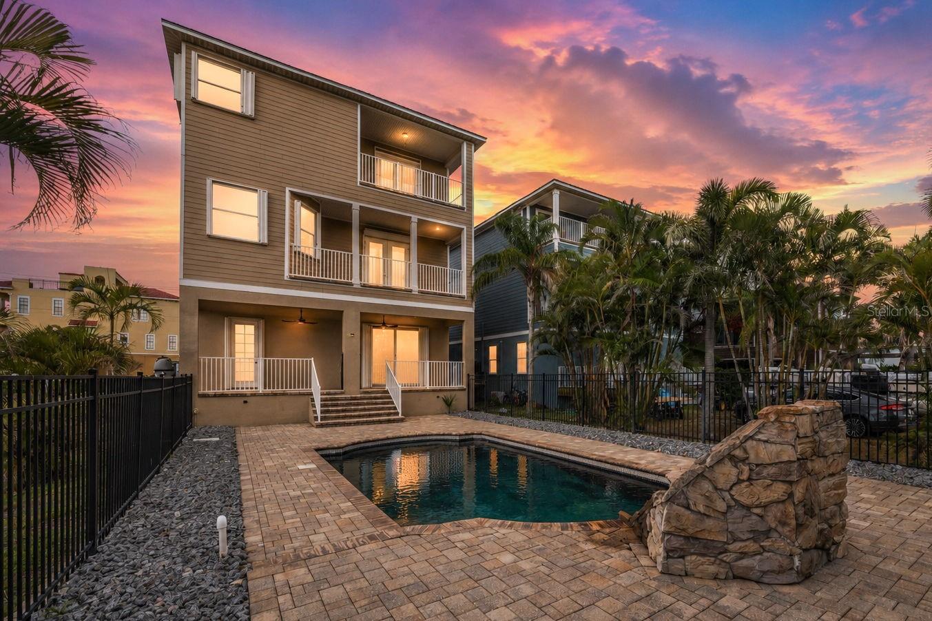 Gorgeous evening view of the pool and rear of the house.