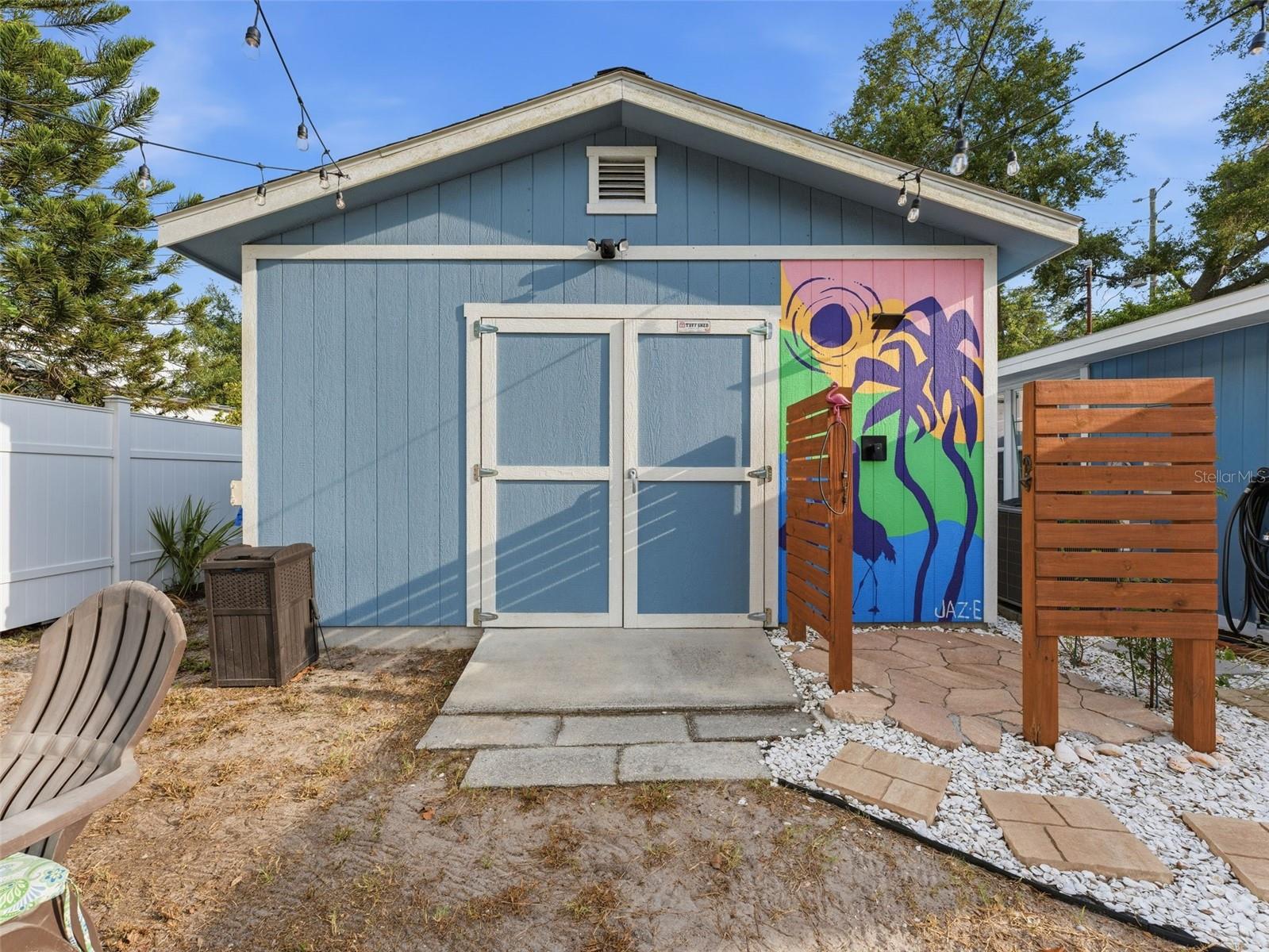 back side of garage with outdoor shower