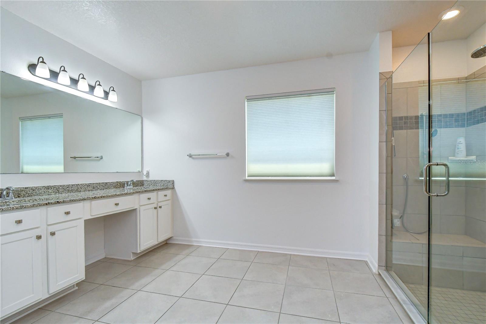 Primary Bathroom with dual vanity and walk-in shower