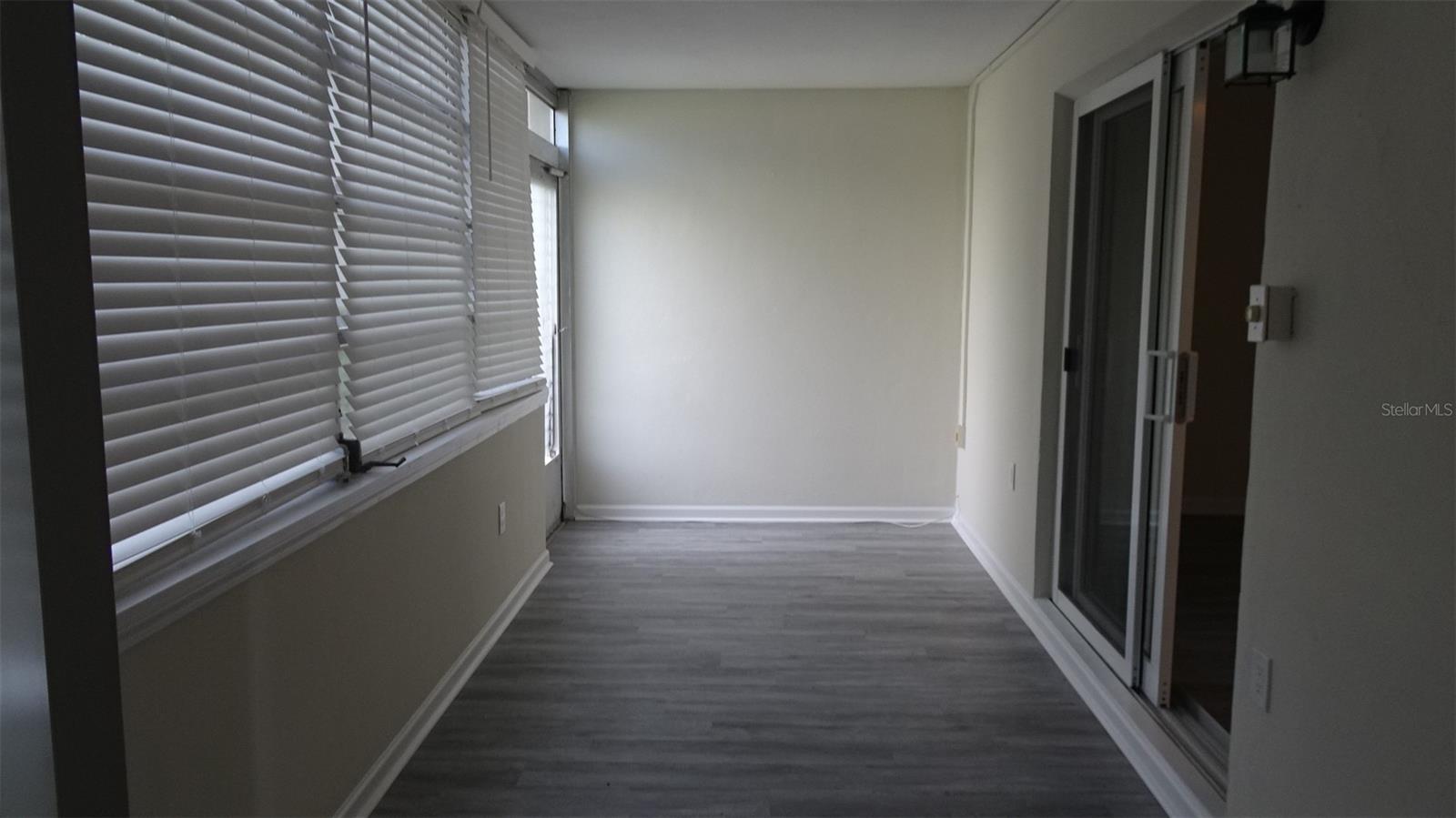 Florida room with rear door, soon to be replaced with a new exterior door.