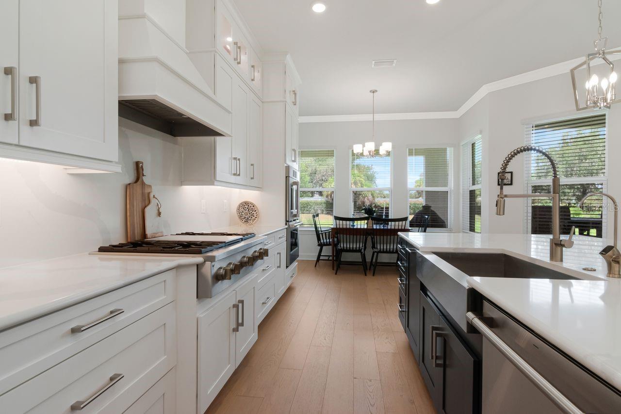 Chef's Kitchen - Quartz - Expansive Island with Storage - Pendant Lighting - Double Ovens - Gas Range & Hood - Butler's Pantry - Cabinets with Crown Molding - Stainless Steel Appliance Package