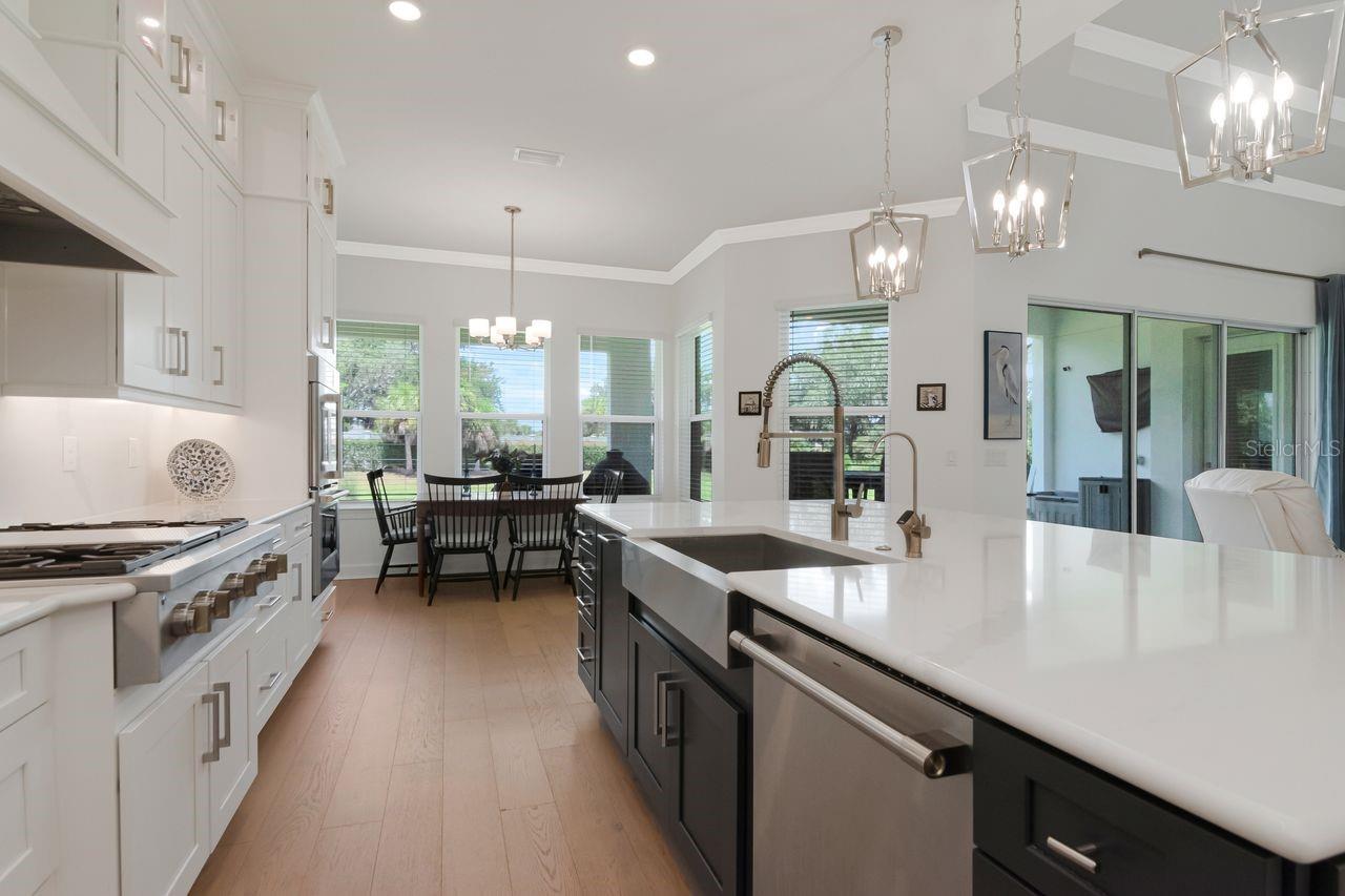 Chef's Kitchen - Quartz - Expansive Island with Storage - Pendant Lighting - Double Ovens - Gas Range & Hood - Butler's Pantry - Cabinets with Crown Molding - Stainless Steel Appliance Package