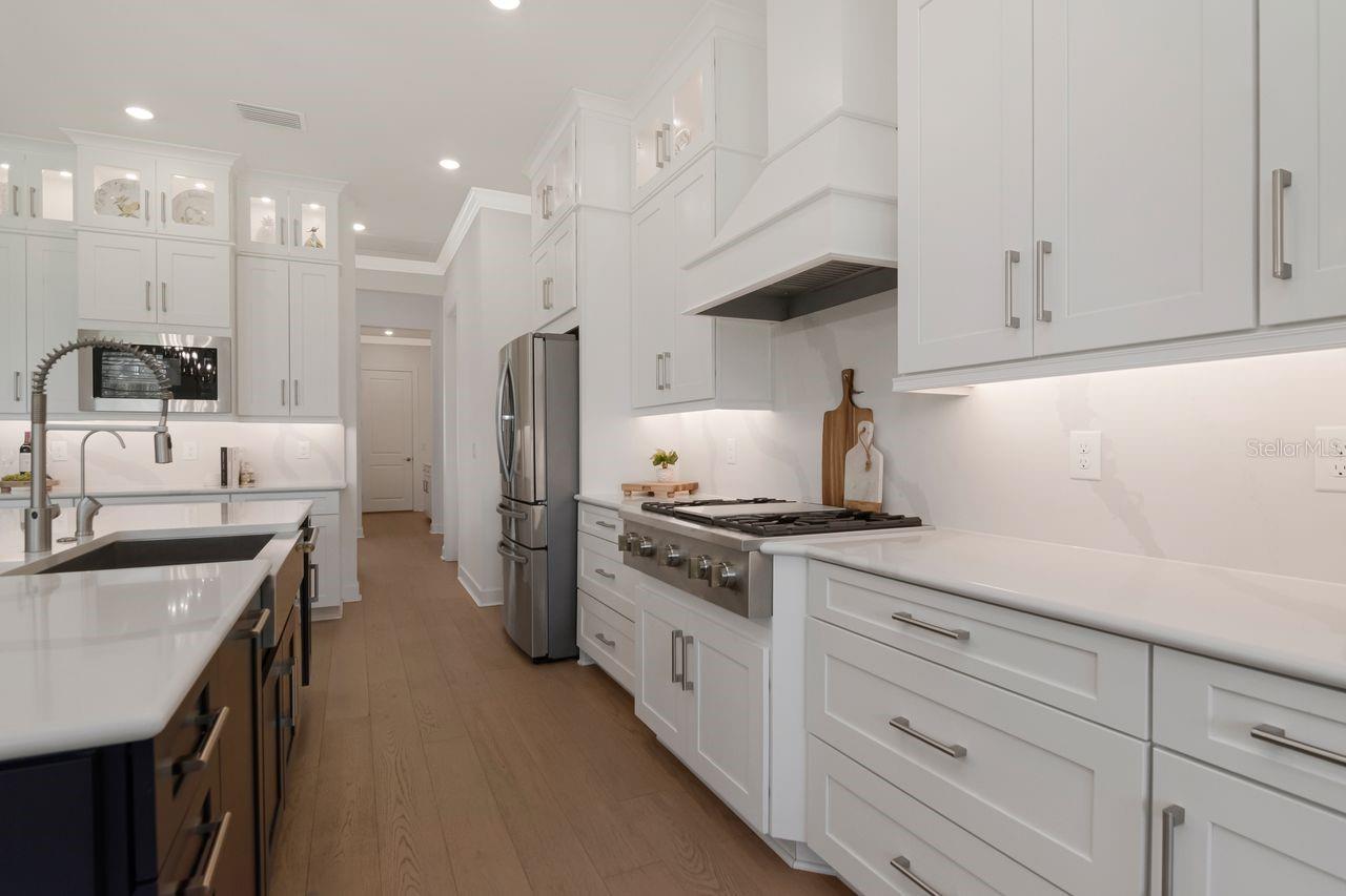 Chef's Kitchen - Quartz - Expansive Island with Storage - Pendant Lighting - Double Ovens - Gas Range & Hood - Butler's Pantry - Cabinets with Crown Molding - Stainless Steel Appliance Package