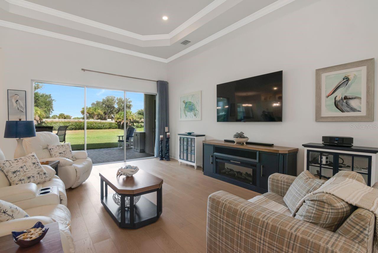 Living Room - Triple Sliding Glass Doors - Tray Ceiling with Crown Molding - Upgraded Ceiling Fan - Engineered Hardwood Floor - Electrical Floor Outlet