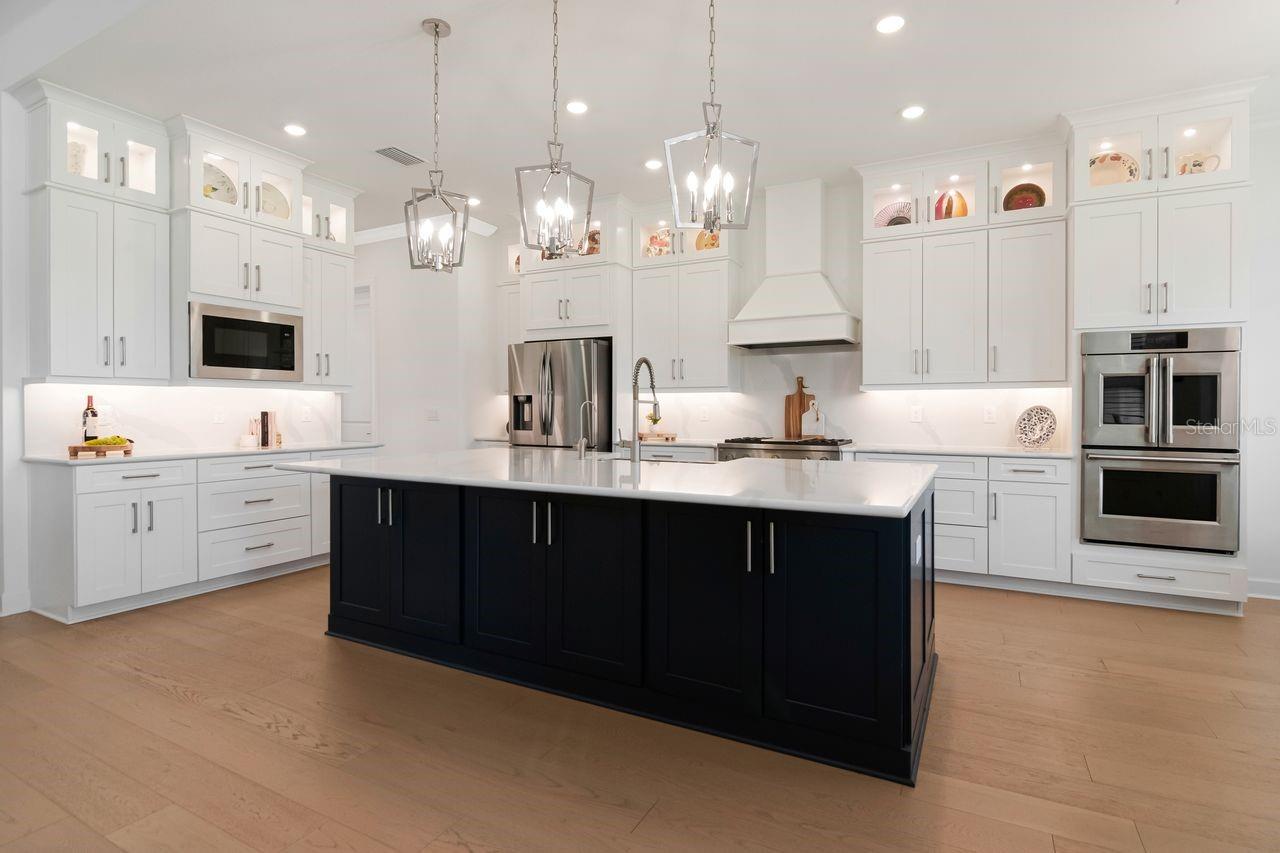 Chef's Kitchen - Quartz - Expansive Island with Storage - Pendant Lighting - Double Ovens - Gas Range & Hood - Butler's Pantry - Cabinets with Crown Molding