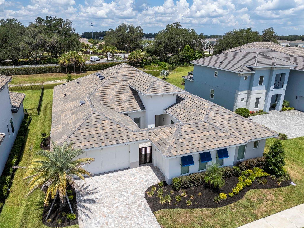 Elevated View of Front of Home - River's Edge Community - Tile Roof - Pavered Driveway