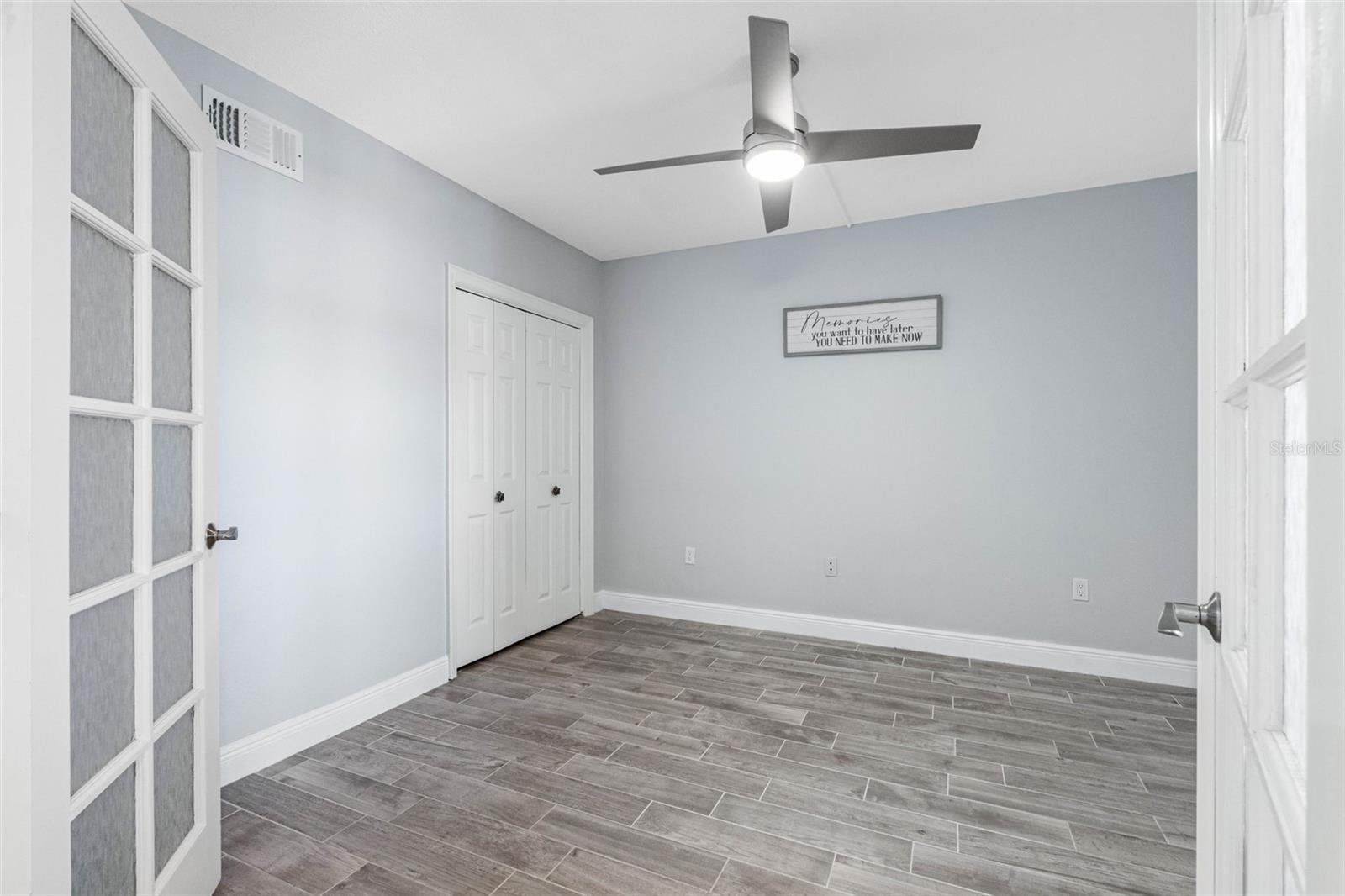 ... Main Floor Guest Bedroom #2 .. New Tile Floors - Closet and French Doors ..