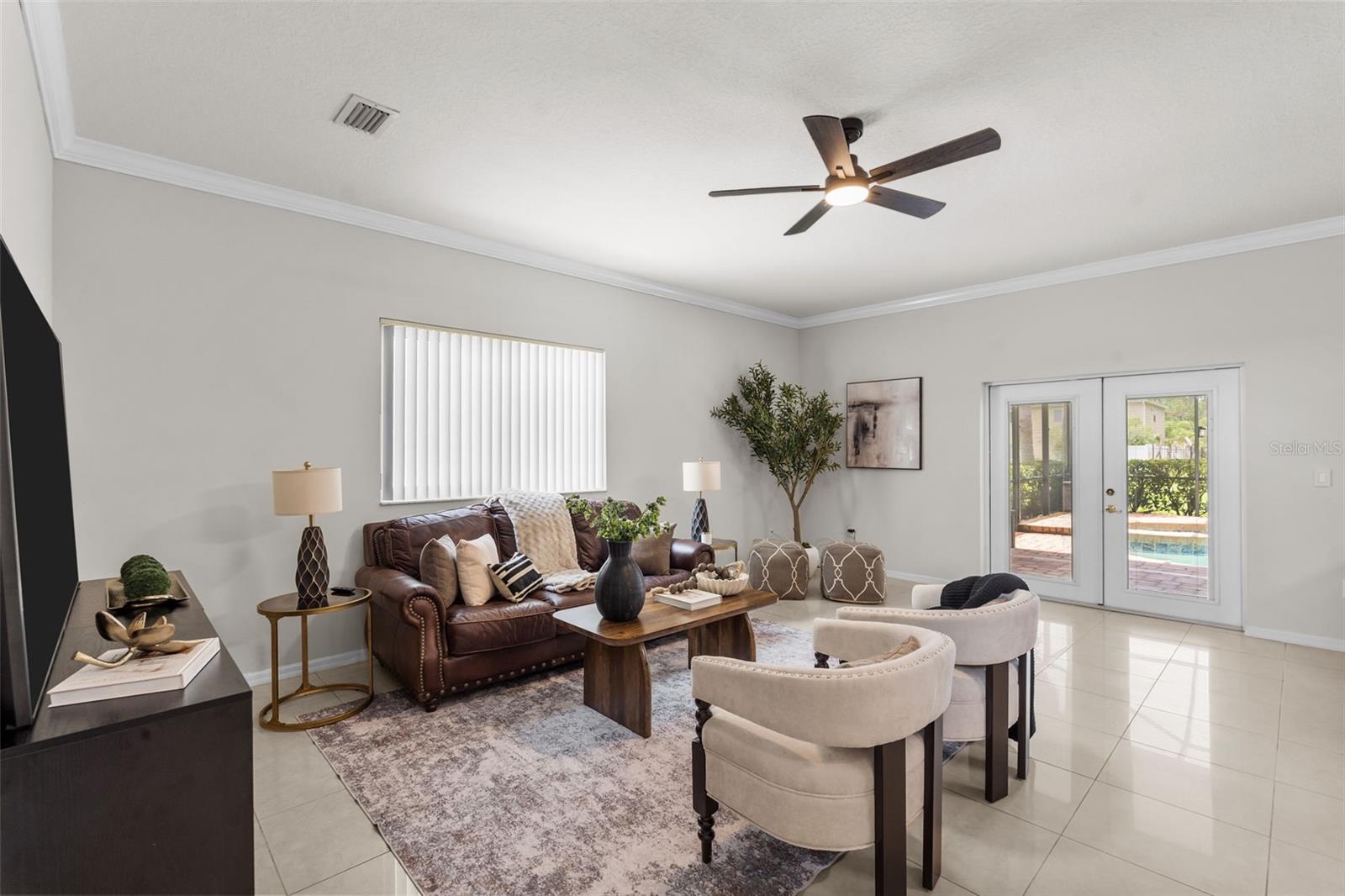 Family Room with french doors that exit to the spacious covered patio and private backyard oasis.