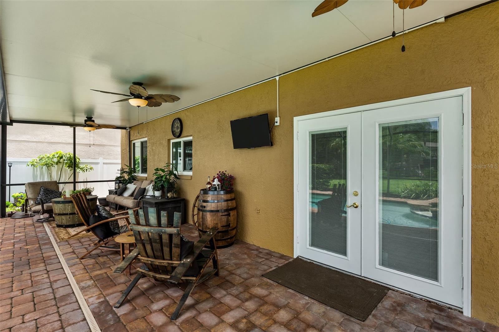 Covered lanai featuring outdoor living space perfect for relaxing or entertaining.