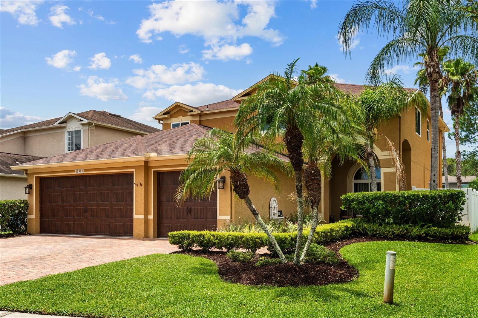 Welcome home! Beautifully landscaped yard, featuring mature native plantings, lush greenery, designed for amazing curb appeal.