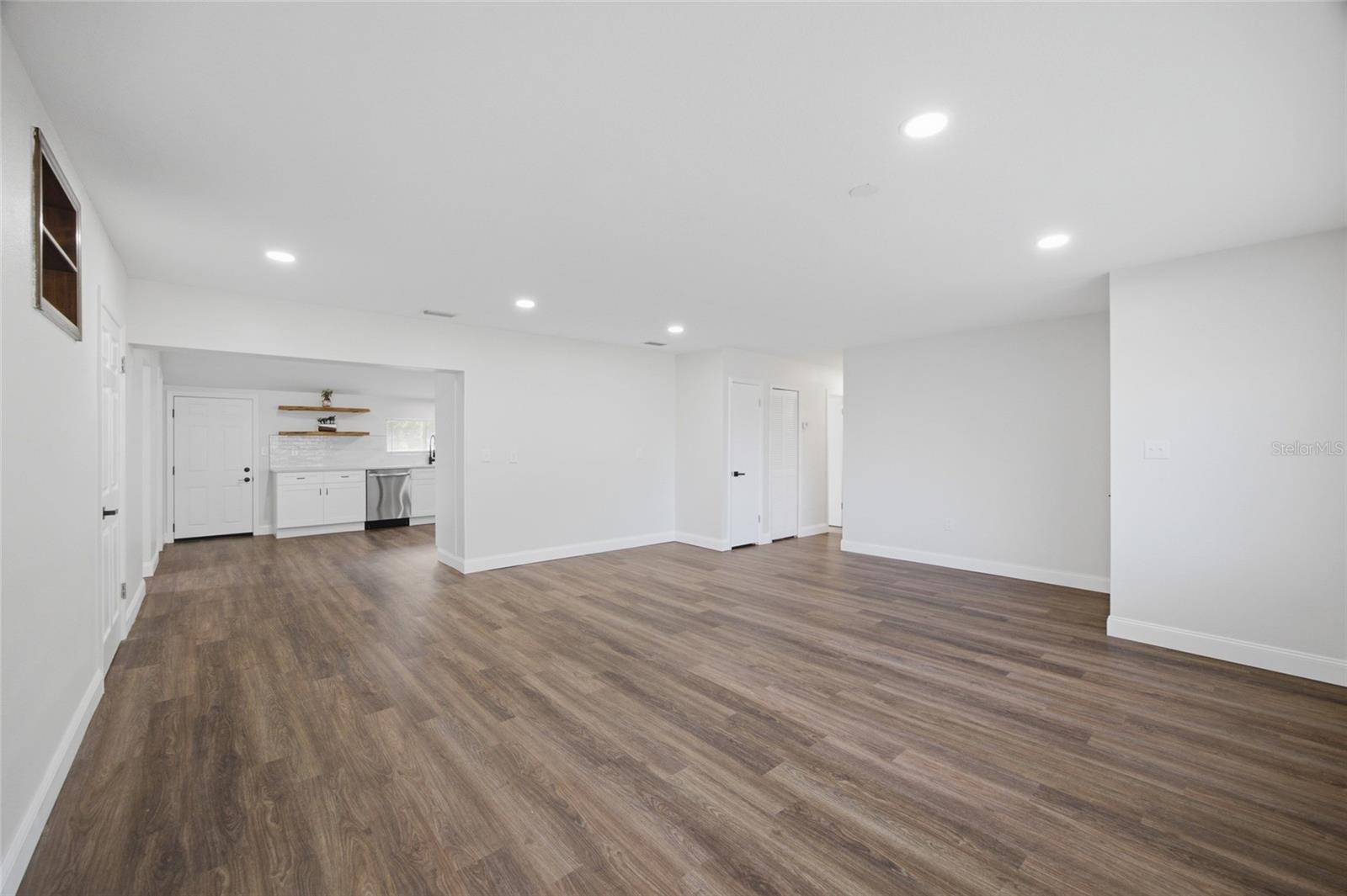 Front door to the right bottom corner of this picture.  Hallway to 3 bedrooms to the right, kitchen straight ahead and office room to the left.