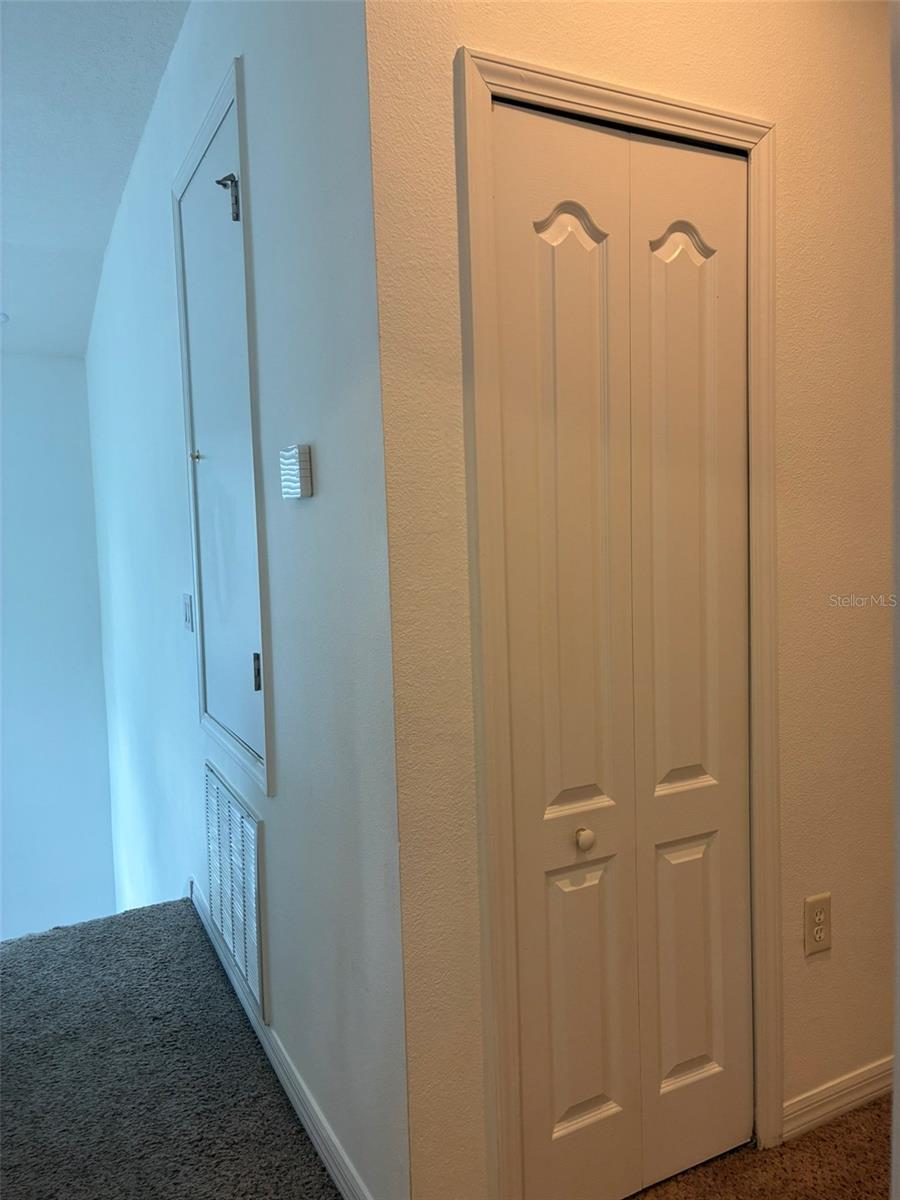 Upstairs hallway with a linen closet