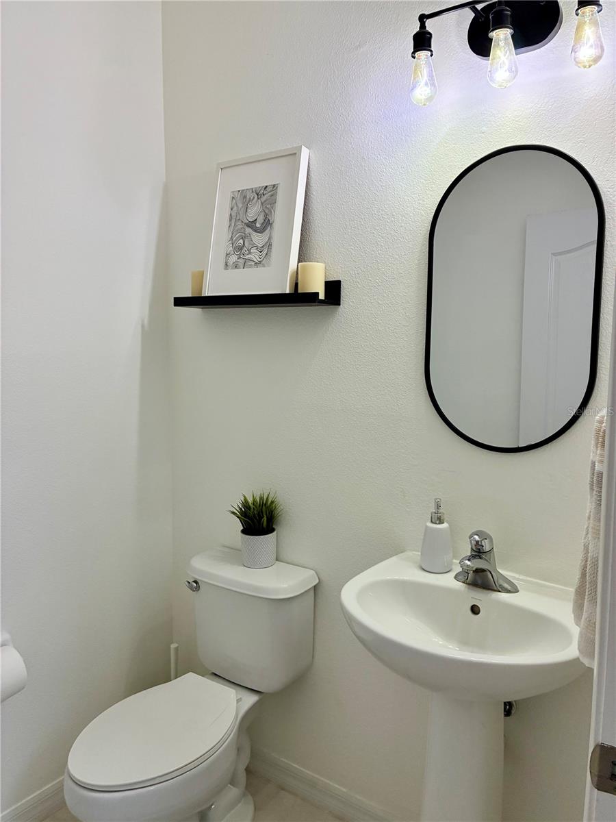 Half bath with closet located right off the entrance