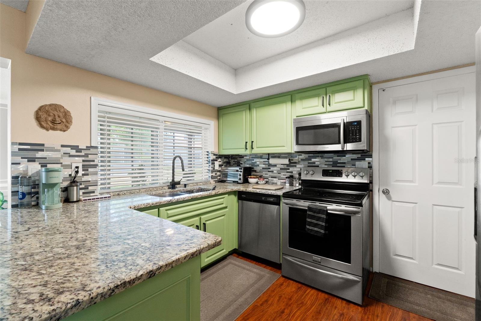 Kitchen with granite counters & stainless steel appliances