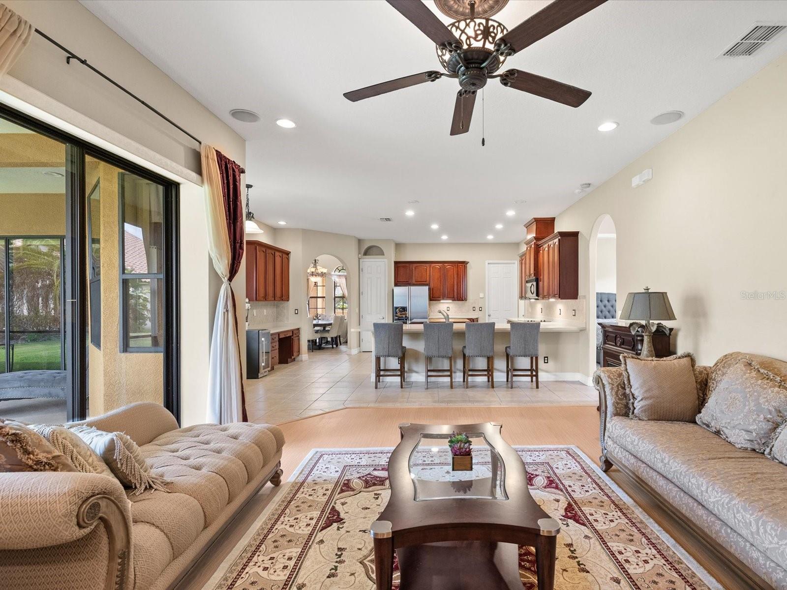 Family Room with 3 Sliders to L shaped enclosed screened patio