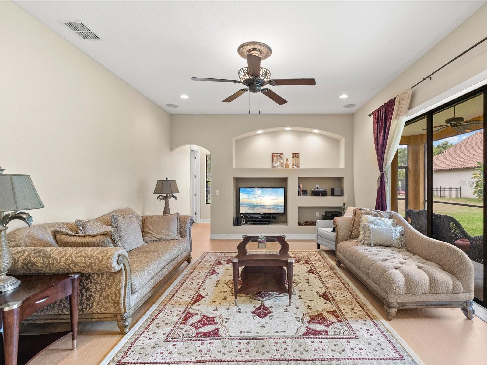 Family Room with 3 sliding glass doors to L shaped patio