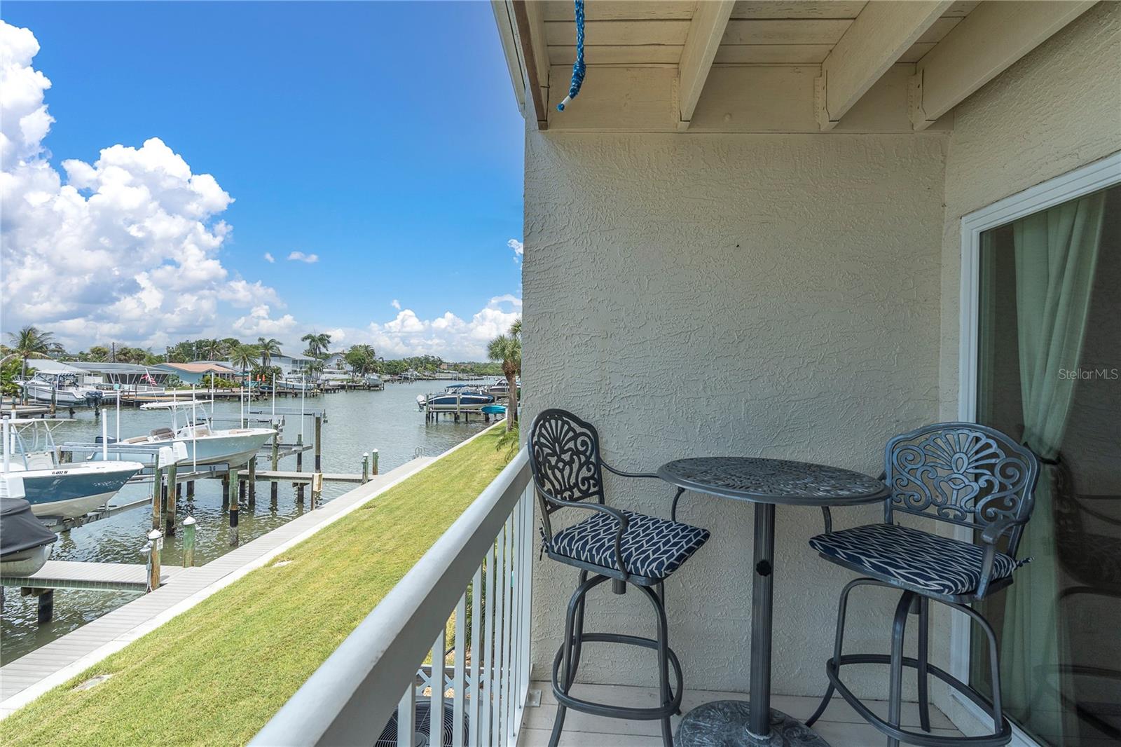 Coffee for two, water views for free. This private balcony overlooks the dock and lift — the perfect perch to start the day before the boat even leaves the slip.