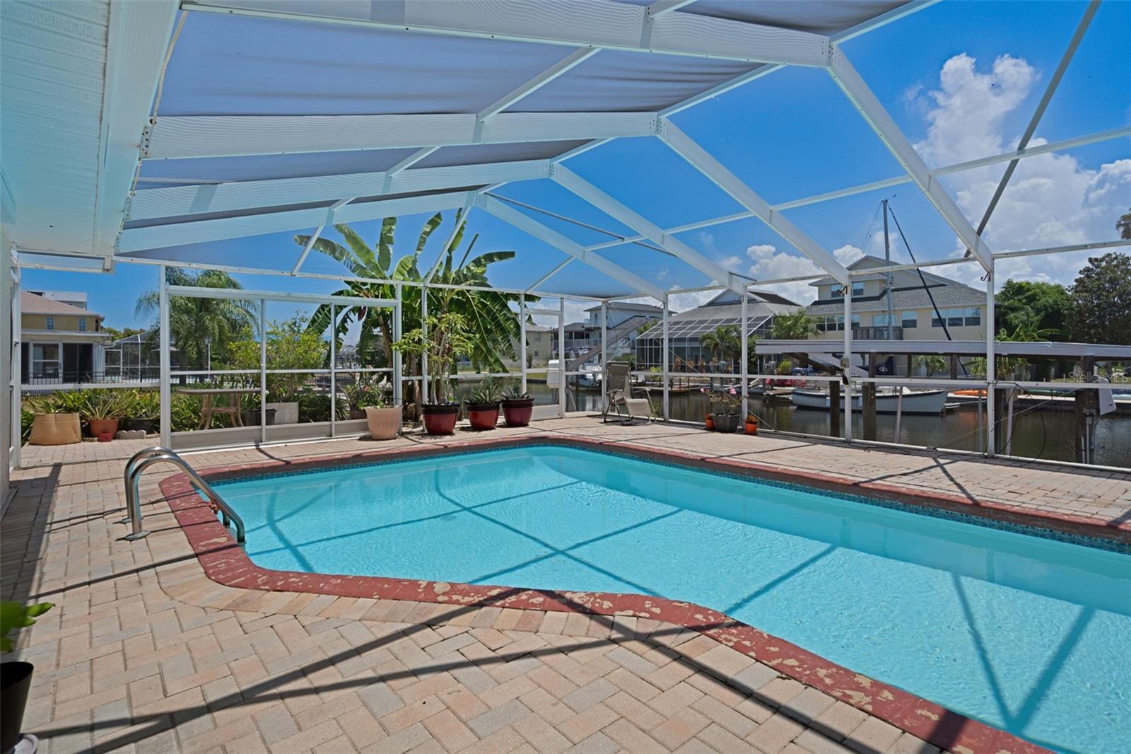 Sparkling Screened Pool Overlooking Canal