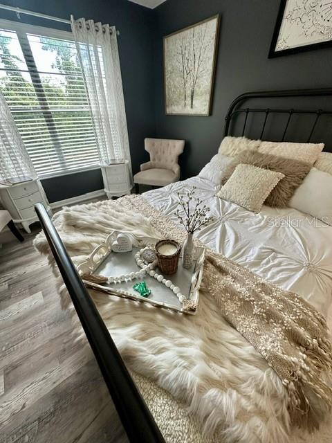 Primary suite with sitting are overlooks the pond and preserve