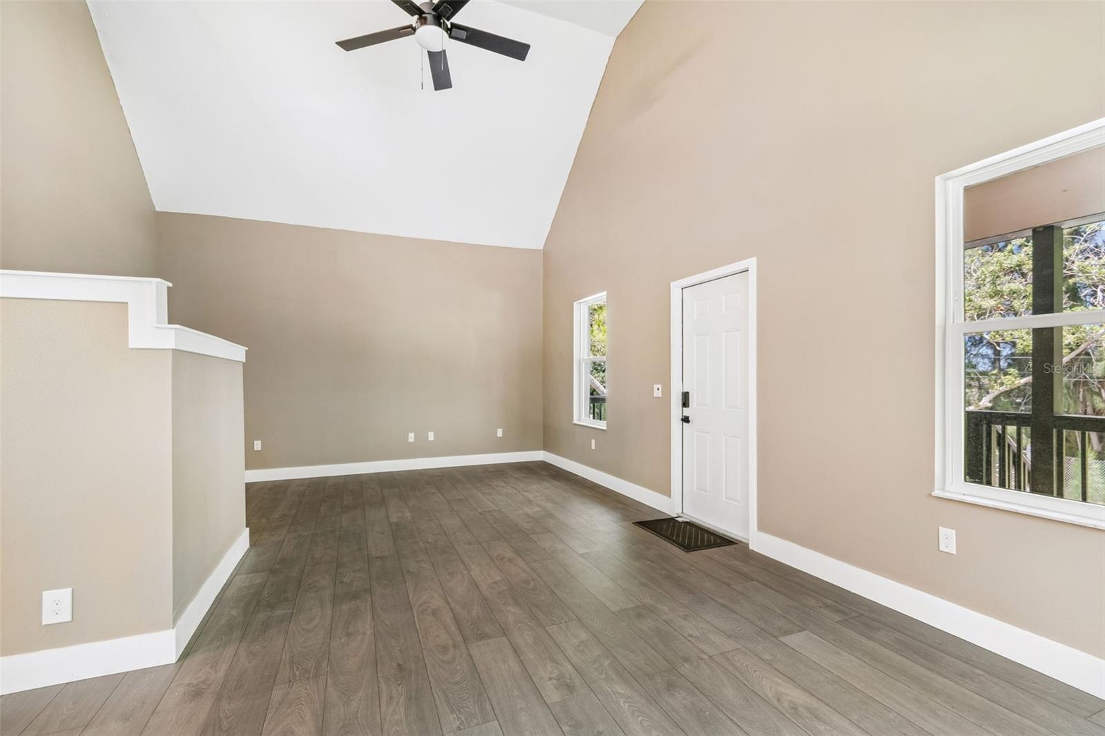 View of the front door from the inside & living room