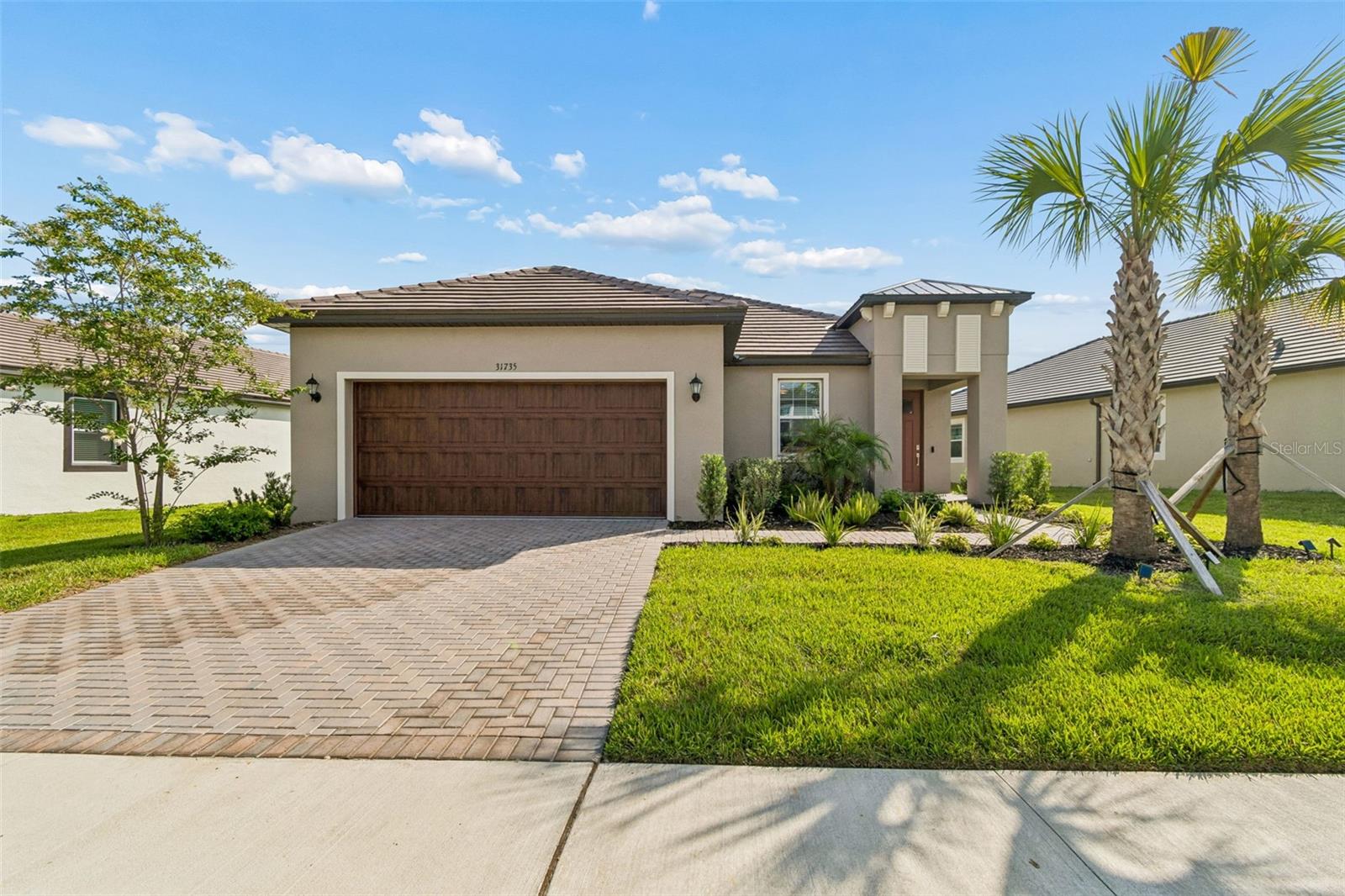 Two car garage with pavered driveway