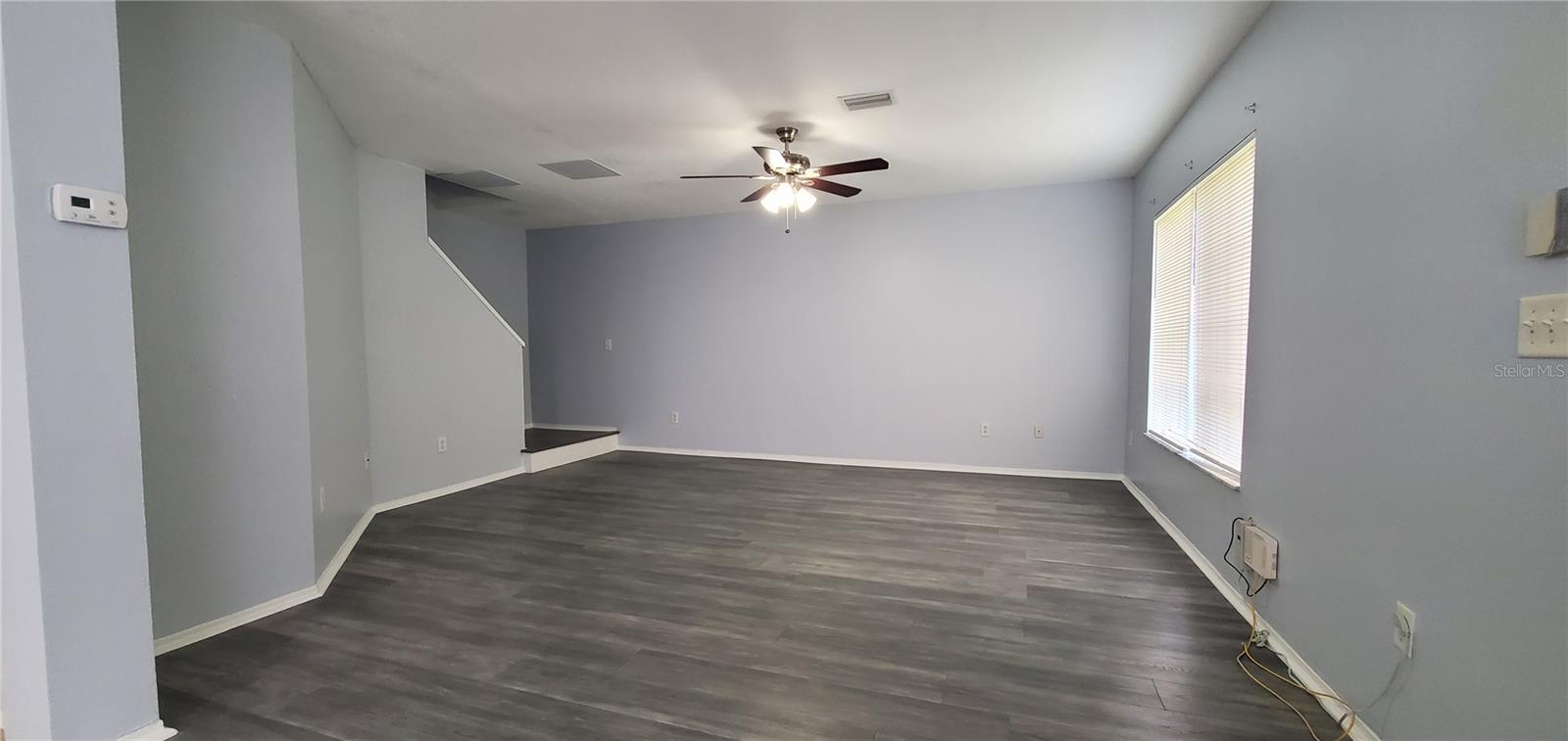 Living Room with Ceiling Fan and New Blinds.
