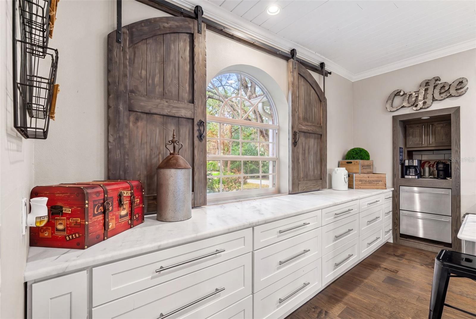 A custom sliding barn-door window treatment adds warmth, character, and a distinctive architectural touch.