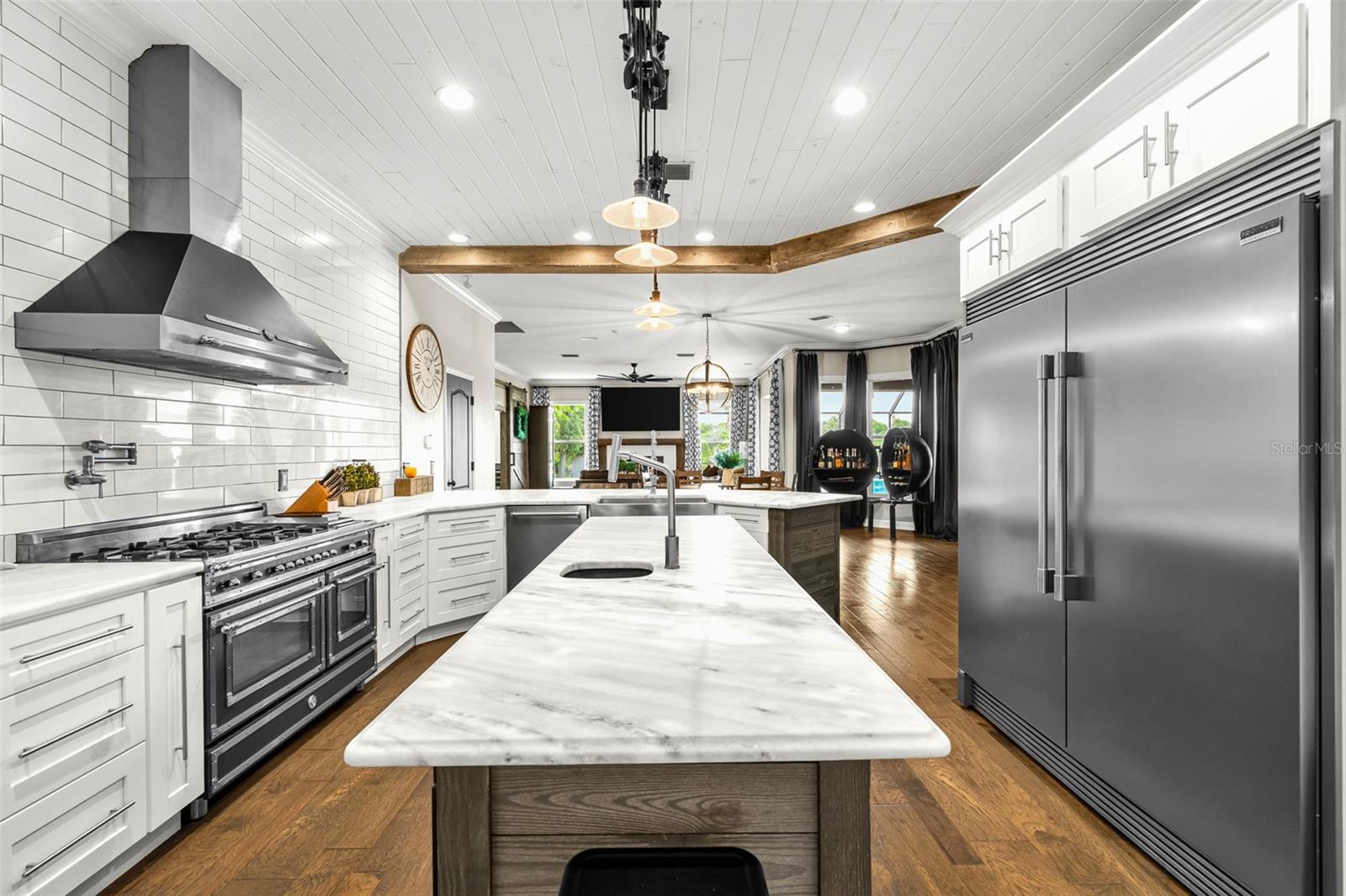 Open to the surrounding living spaces, the kitchen keeps family and guests connected while remaining the home's natural gathering place.