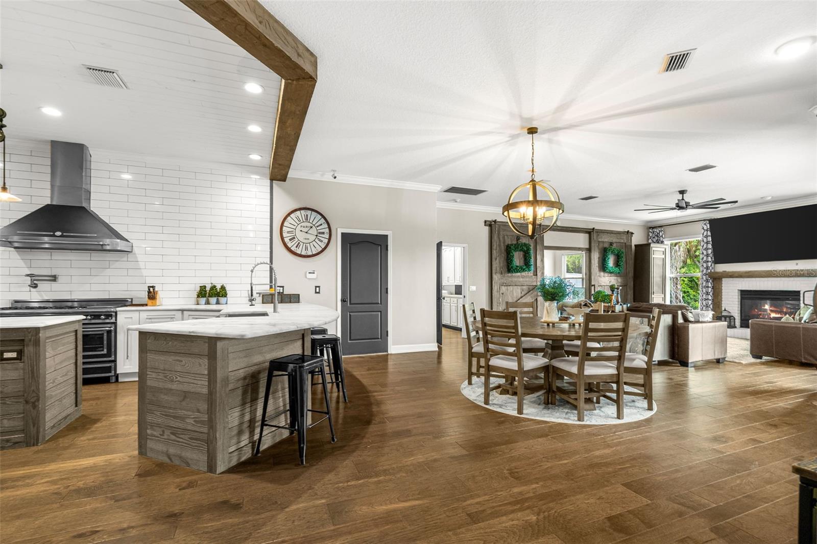 Anchored by the chef's kitchen, this light-filled gathering space brings together casual dining, conversation, and everyday living in one beautifully connected setting.