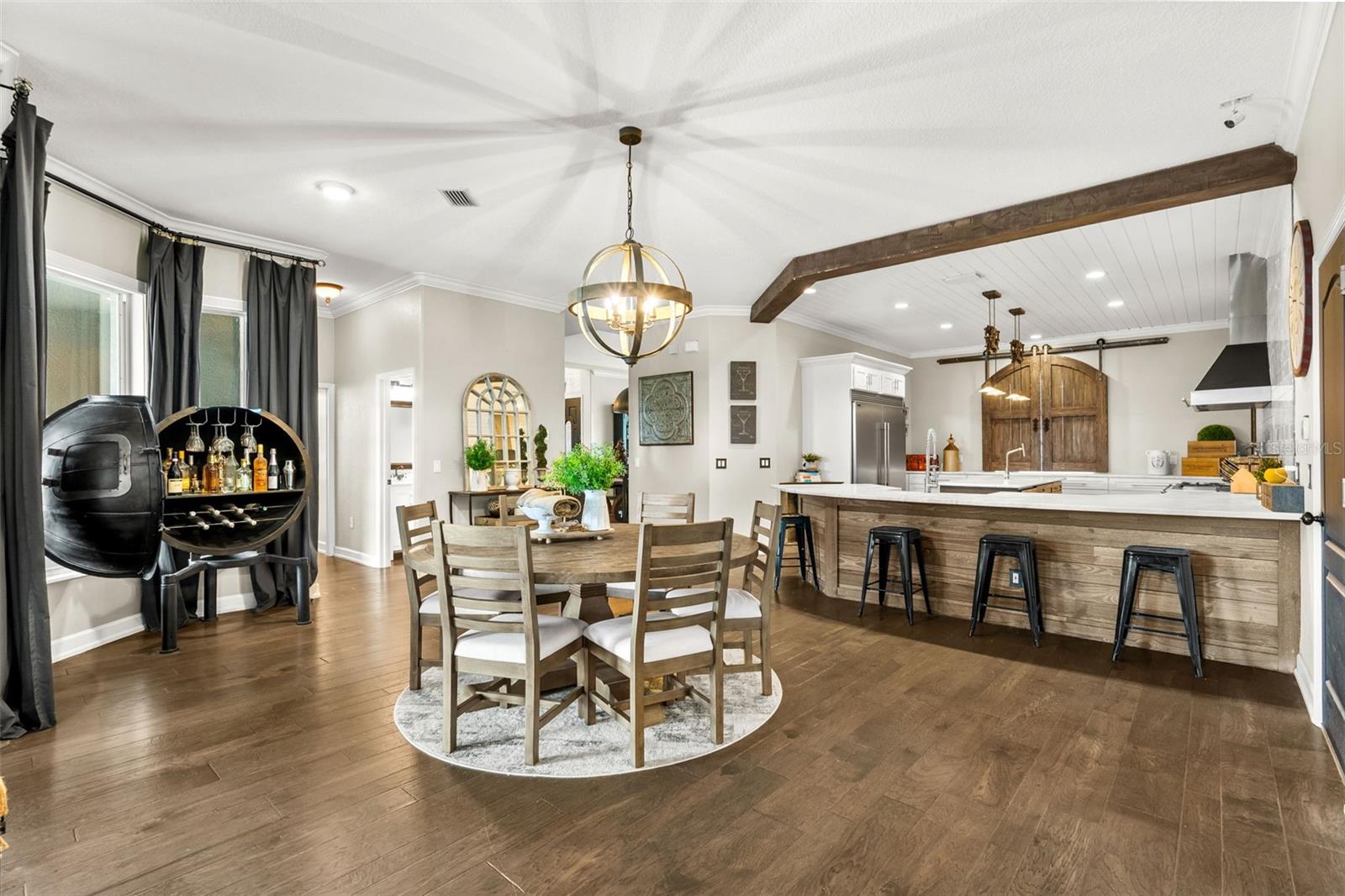 Thoughtfully designed for the way families live and entertain, this open living area provides effortless access to the dining nook, bar seating, laundry room, garage, and nearby guest baths.
