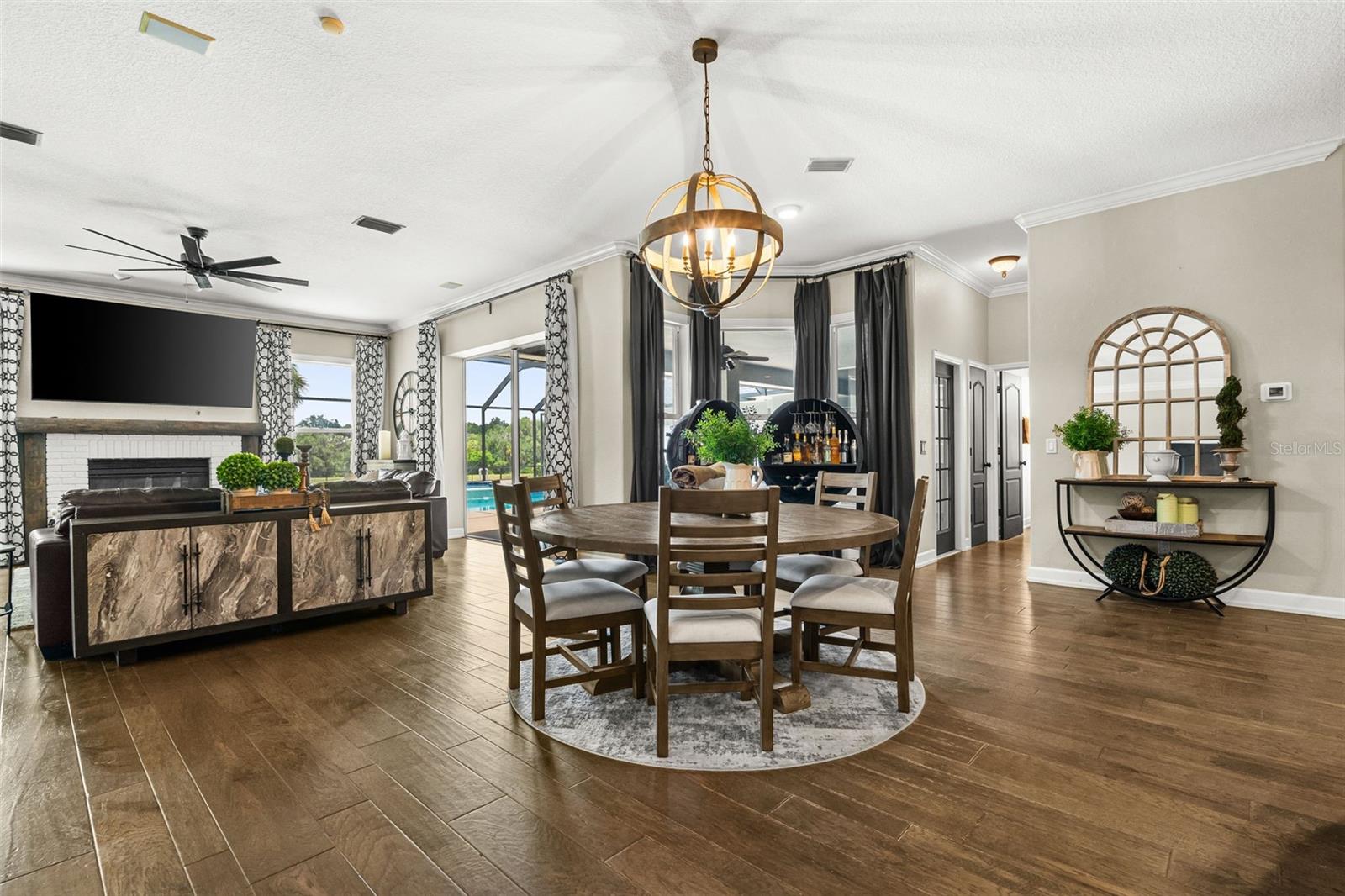 As the home continues to unfold, the breakfast area provides a welcoming transition from the chef's kitchen to the inviting family room and pool beyond.