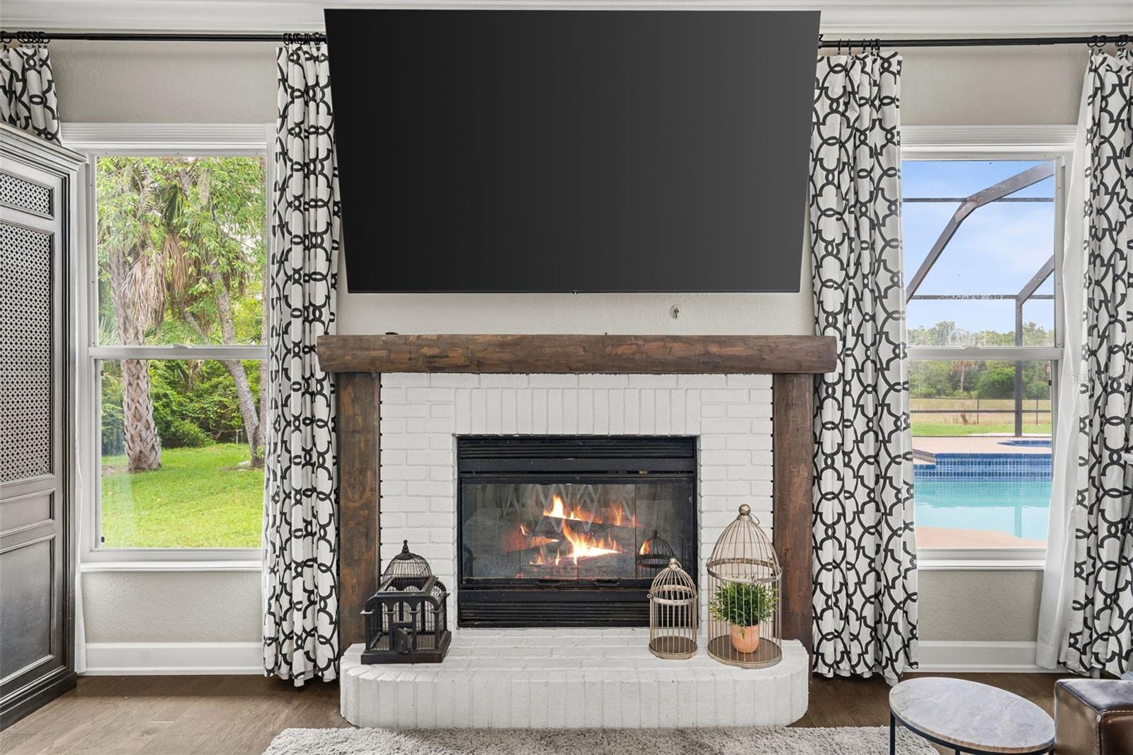 Framed by expansive windows and views of the pool, the fireplace creates a warm focal point that can be enjoyed year-round.