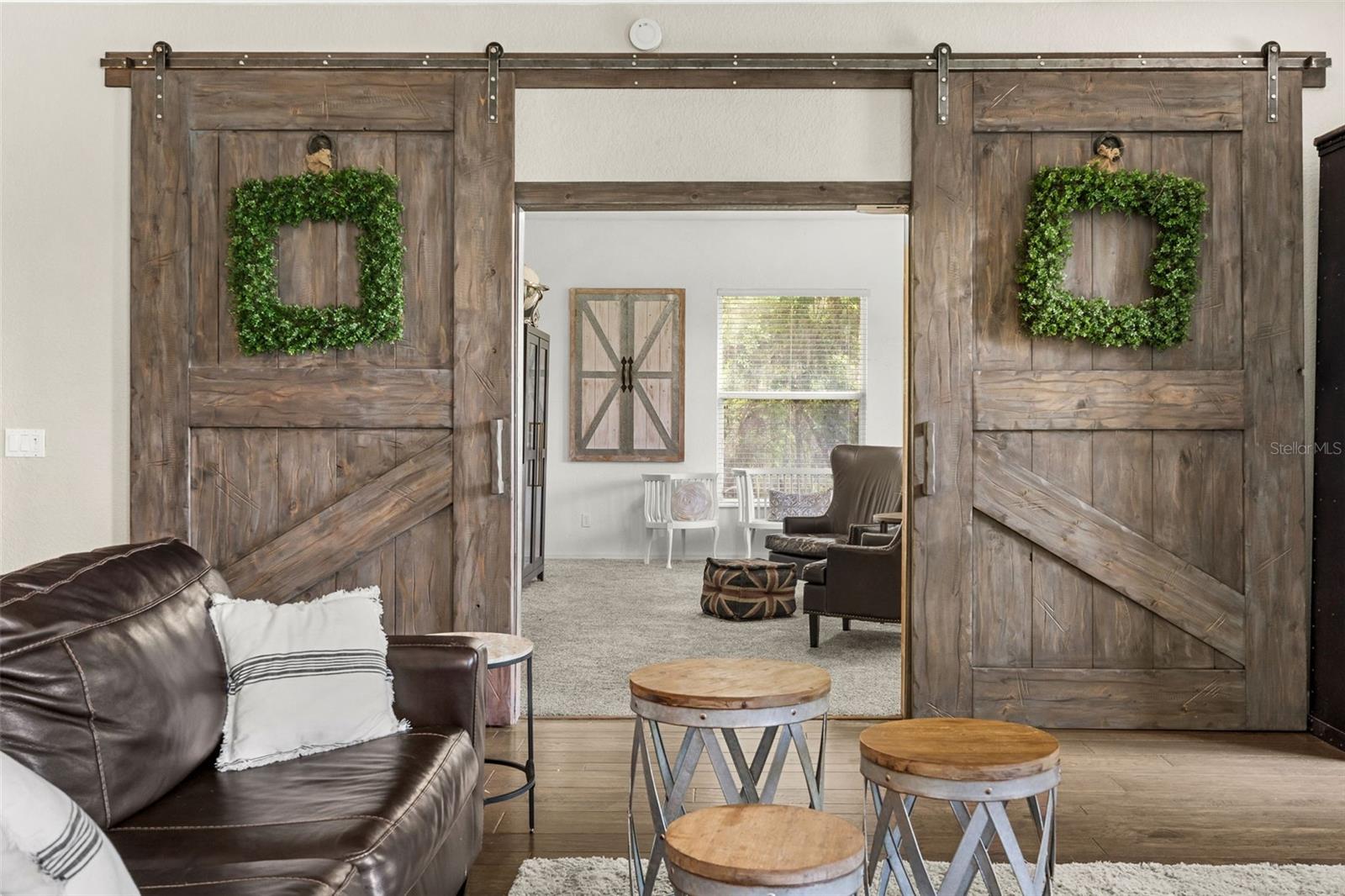 Behind sliding barn doors enter the Bonus Room or extra Bedroom with Walk-in Closet