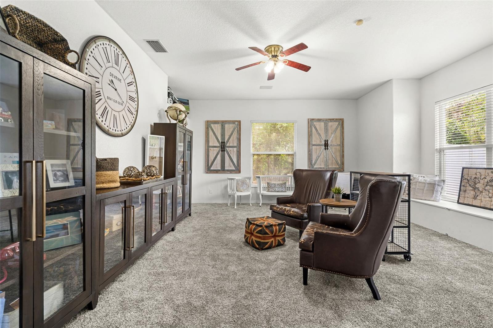 Behind custom barn doors, this versatile bonus room adapts beautifully to your lifestyle—whether as a media room, home office, game room, or private guest retreat.