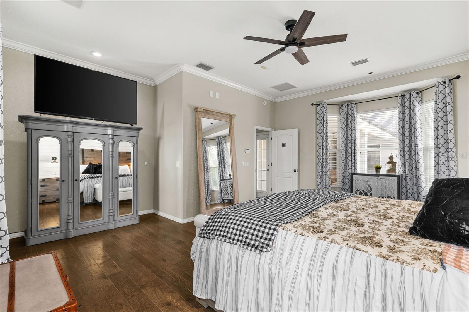 Generous in scale and thoughtfully designed, the primary suite offers a private connection to the outdoor living area and the luxurious owner's bath beyond.
