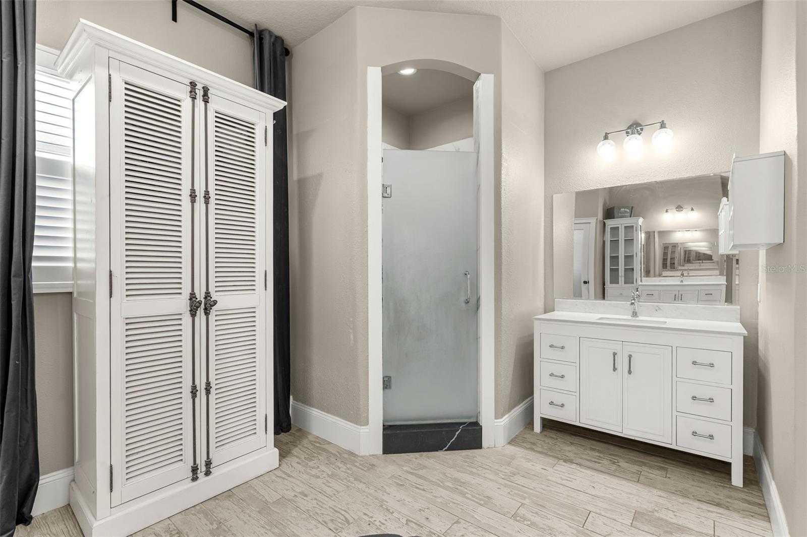 With direct access to the pool and outdoor living area, the owner's bath seamlessly extends the luxury and convenience of the primary suite.